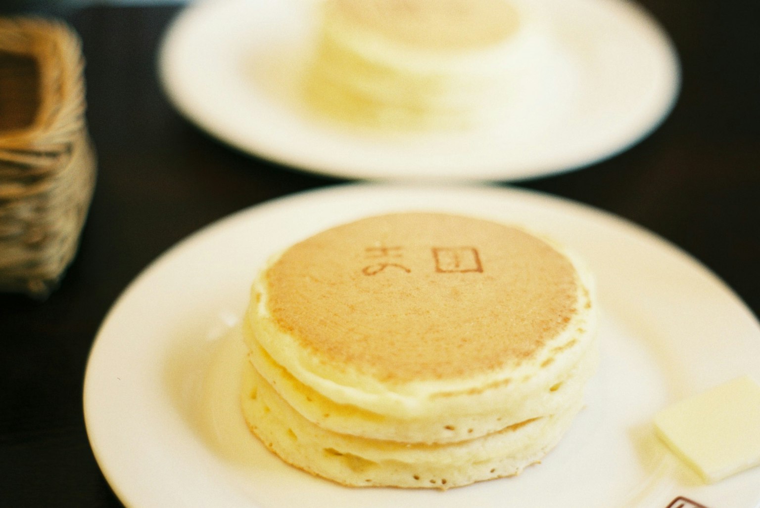 Fluffy pancakes stacked with a stamped design on top