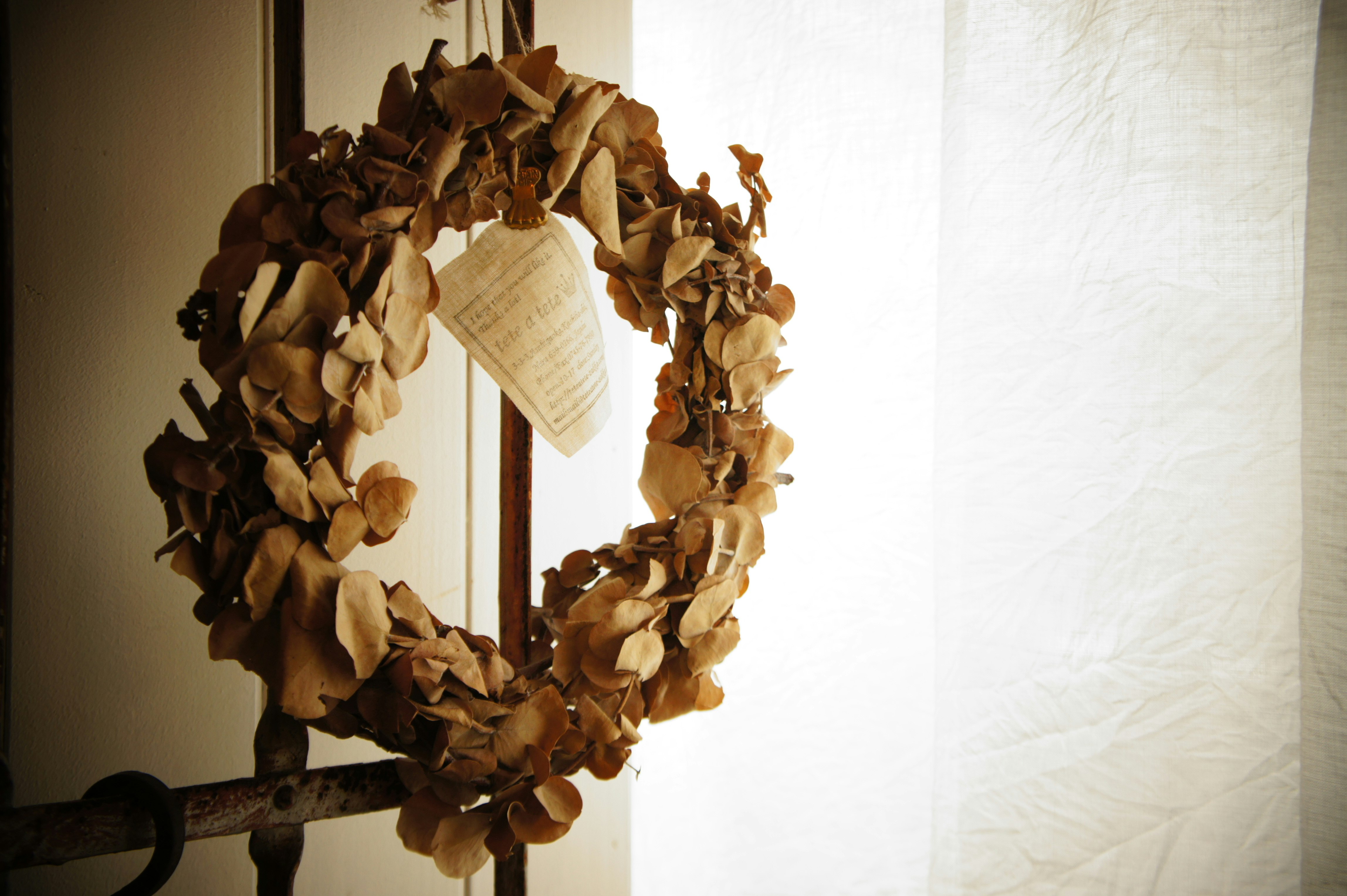 dried flower wreath on a wall in an indoor room
