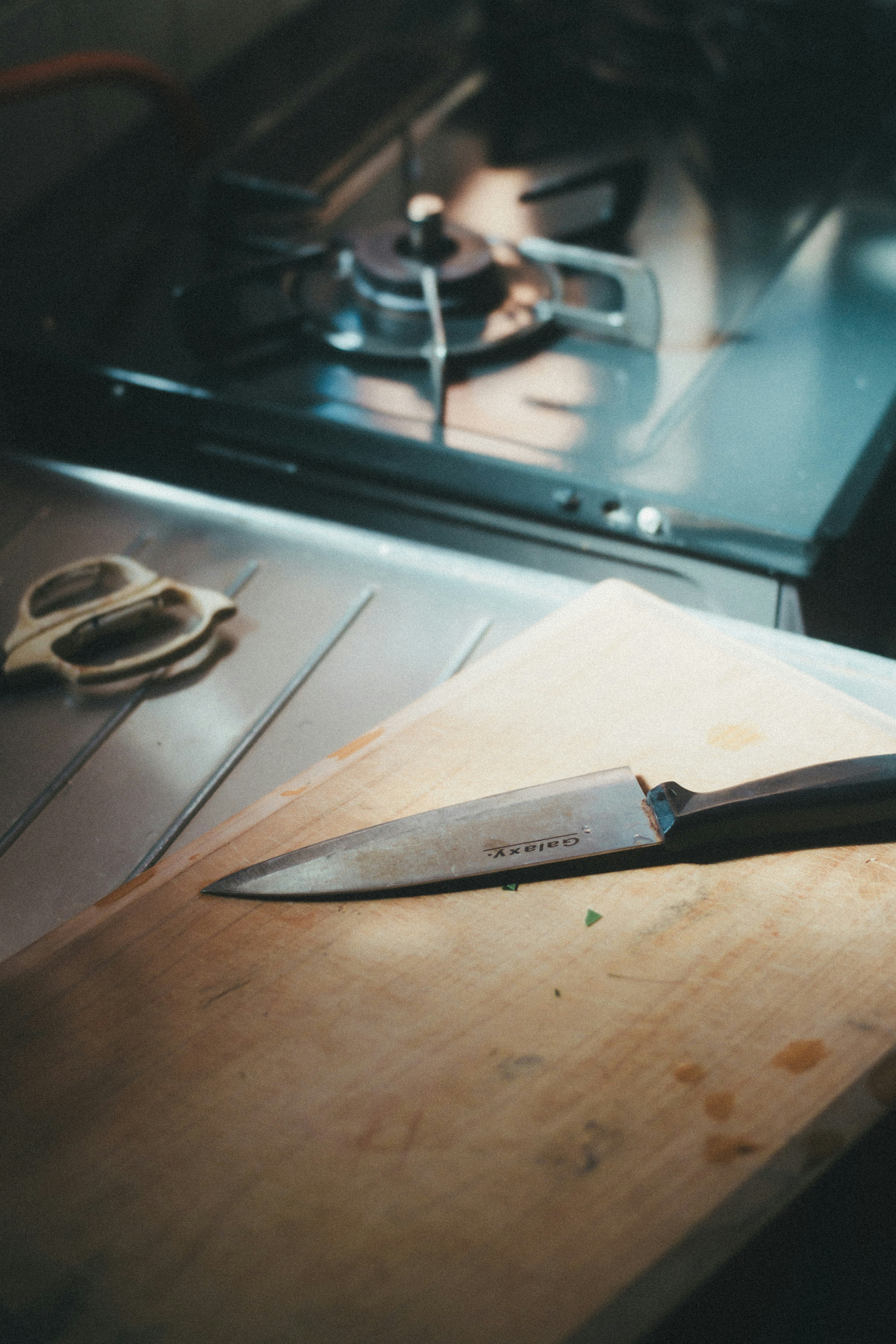 Chef’s knife and kitchen tools on a cutting board