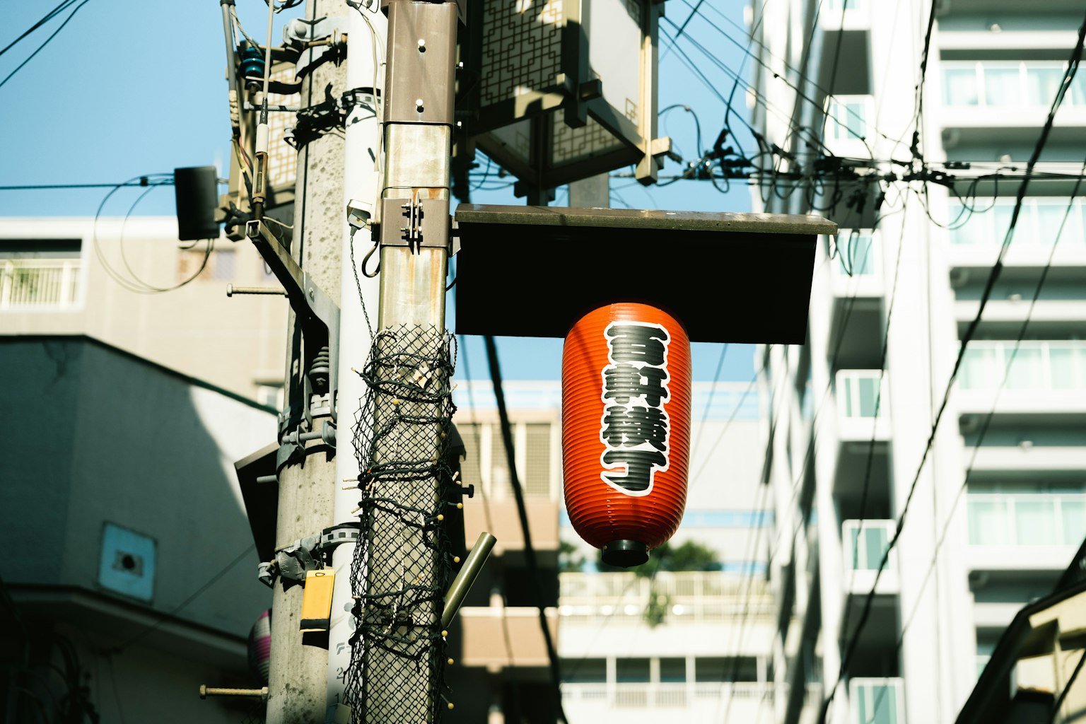 Street view featuring a red lantern hanging from a sign