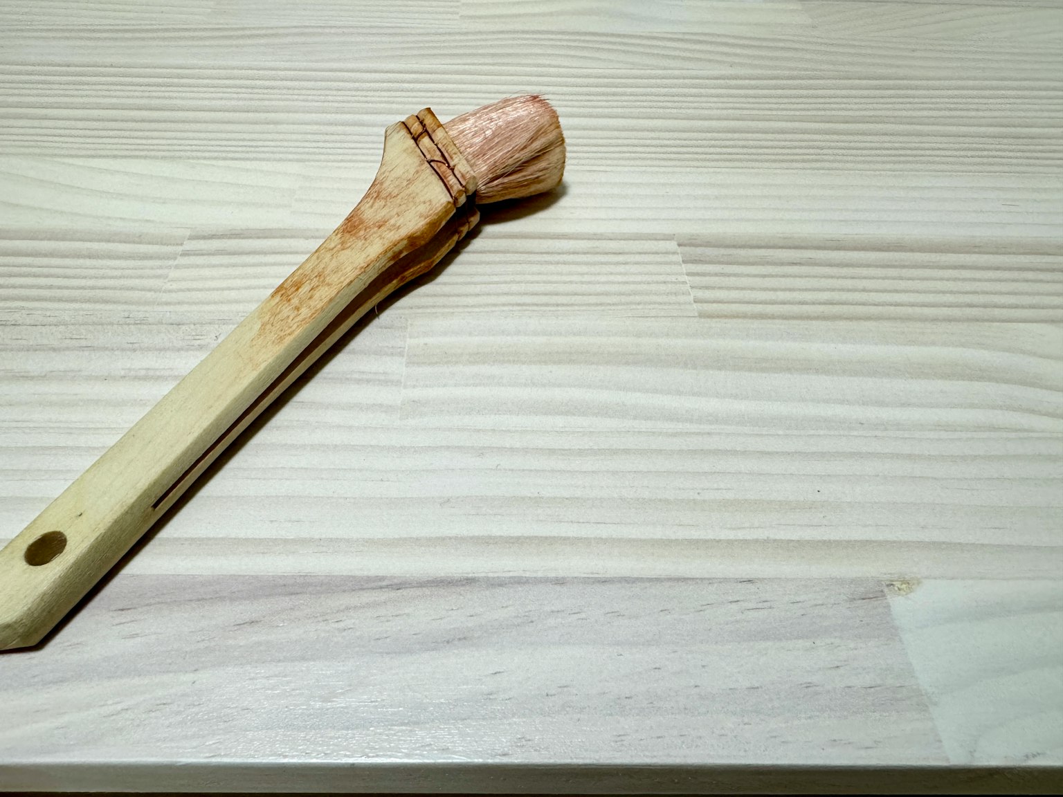 Sikat kayu yang diletakkan di permukaan kayu terang