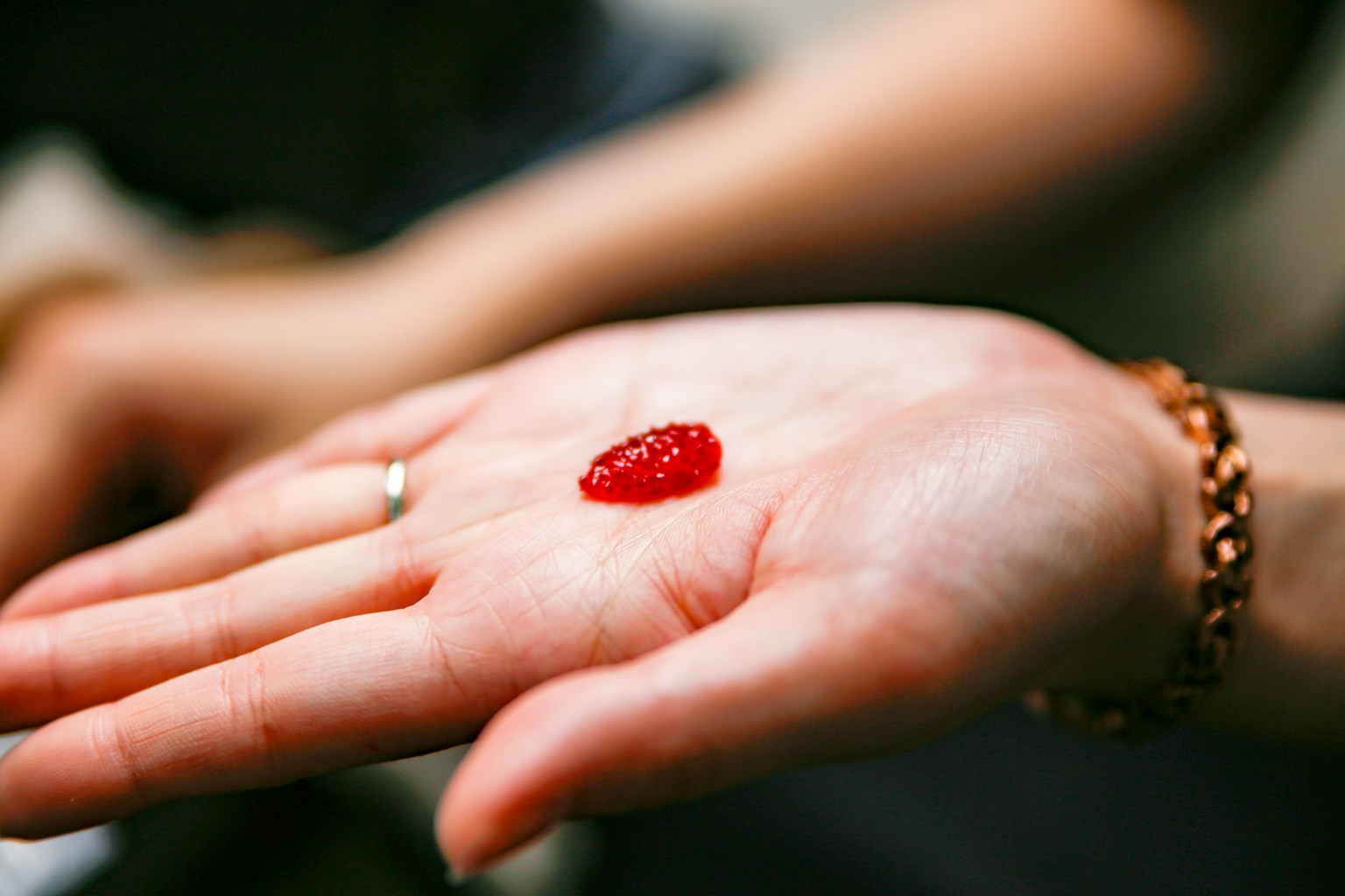 A red jelly-like substance placed on an open palm