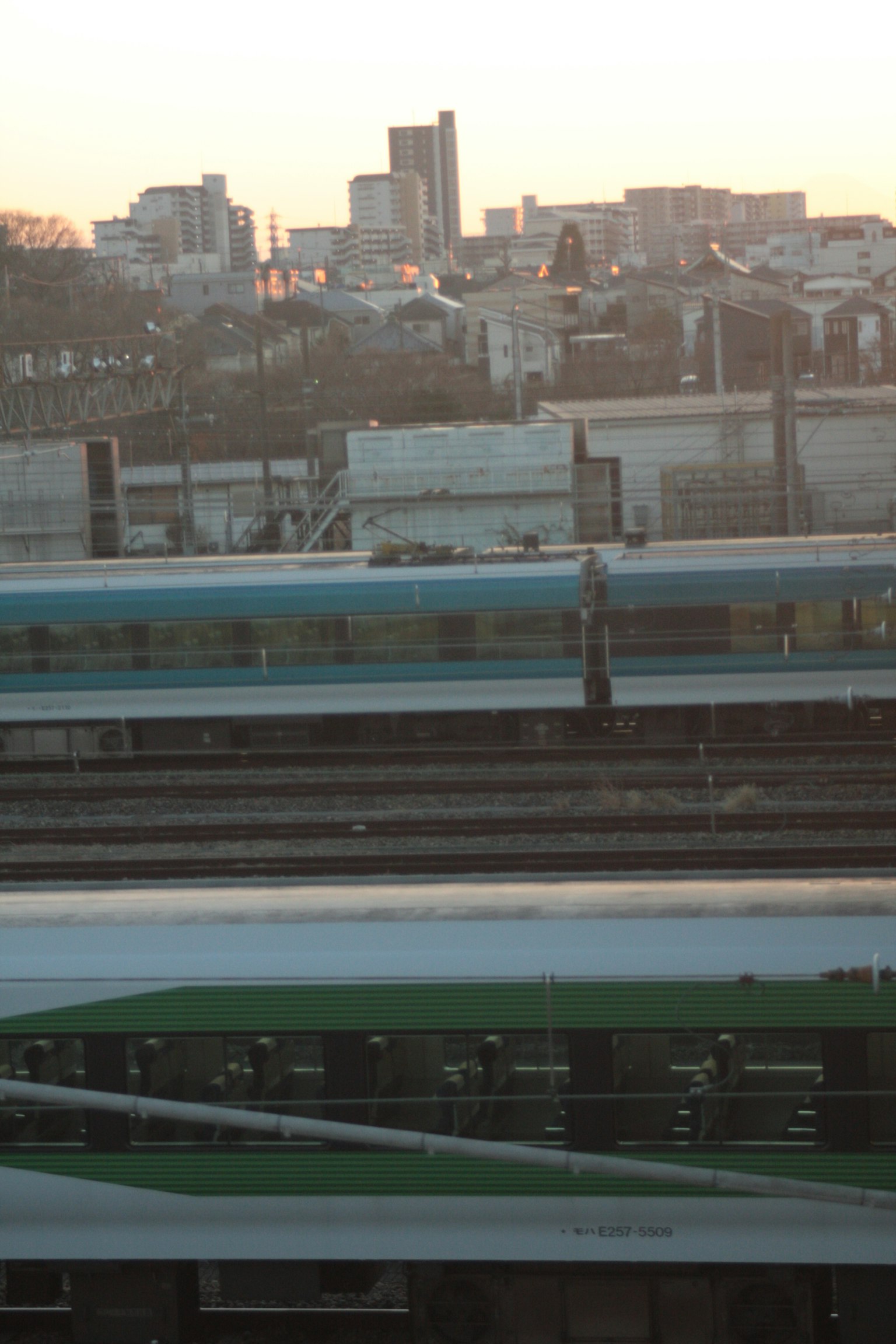 Cityscape at dusk with visible train tracks