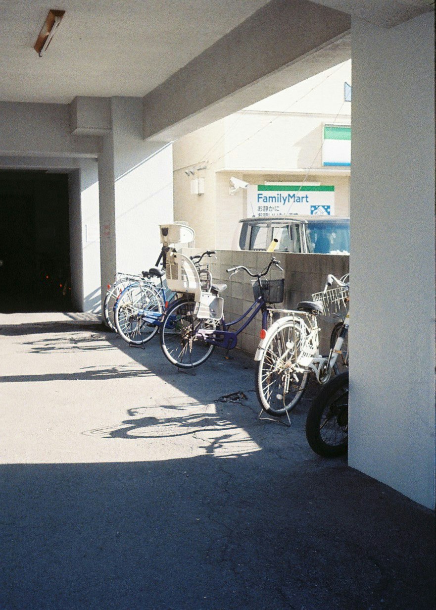 Bicycles parked under a covered arcade overhang