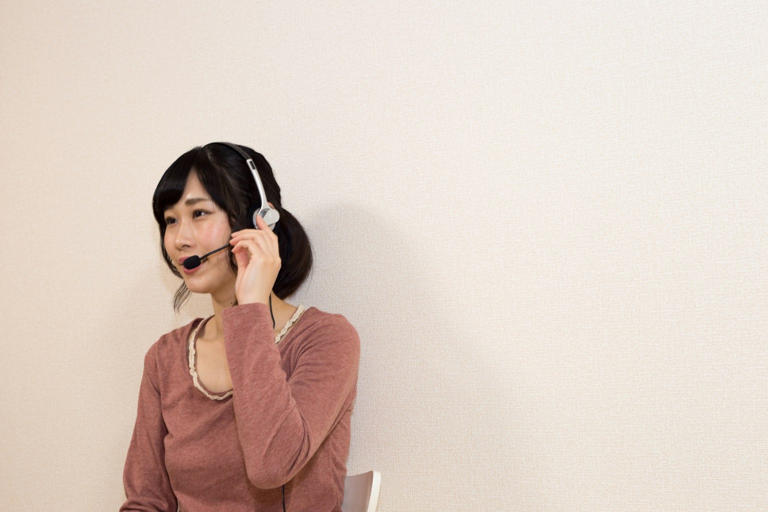 A woman wearing a headset speaking