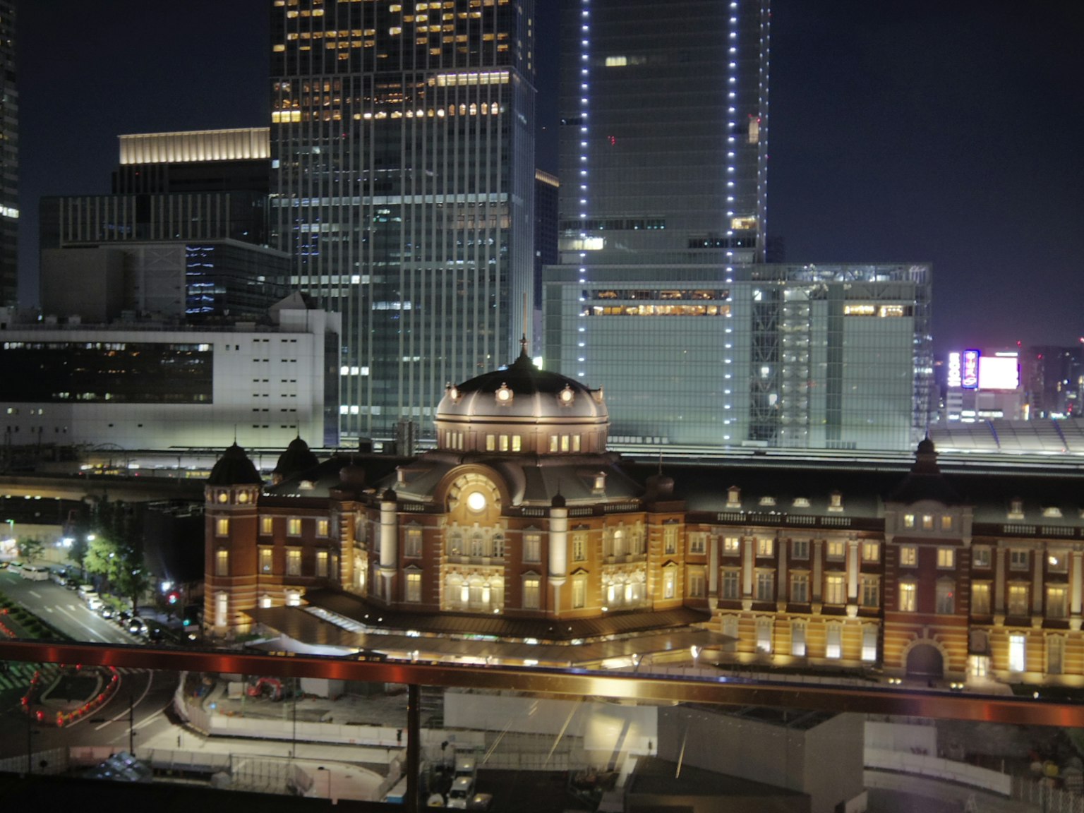 Arsitektur indah Stasiun Tokyo yang diterangi di malam hari dengan gedung pencakar langit modern