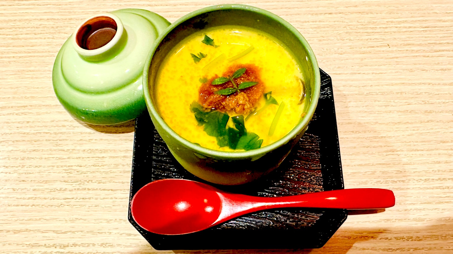 Chawanmushi in einer grünen Schüssel mit Koriander und Hackfleisch serviert