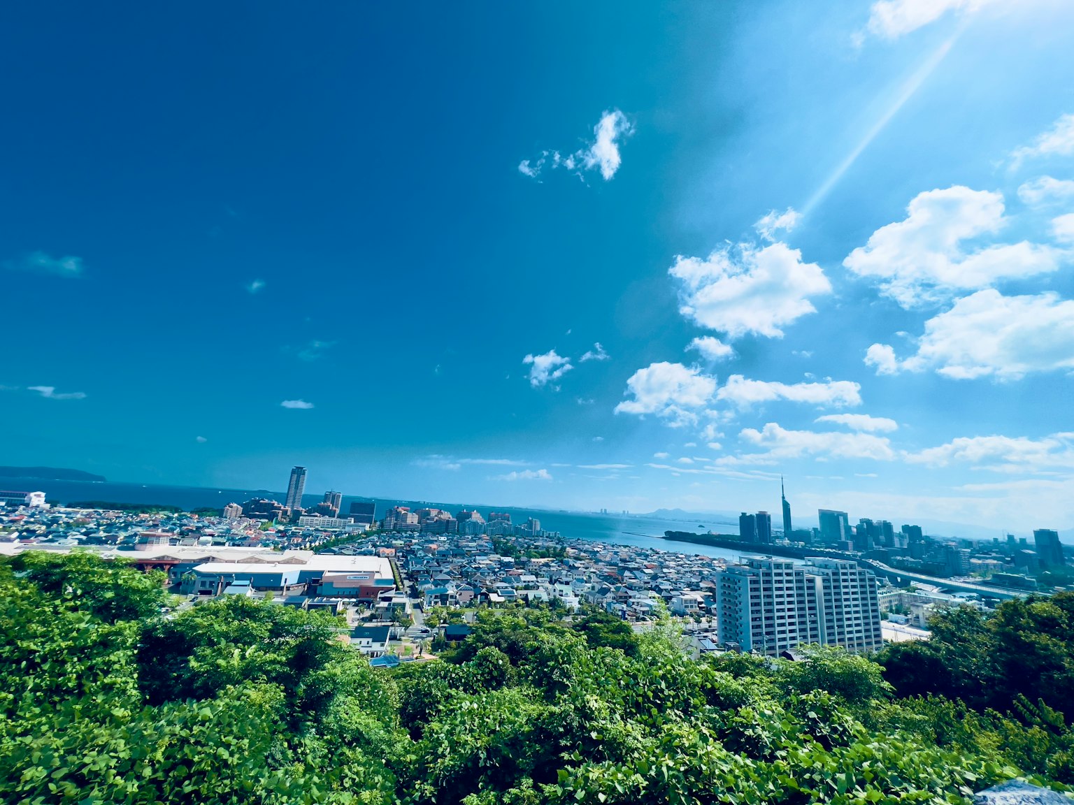 Cityscape with blue sky and scattered clouds