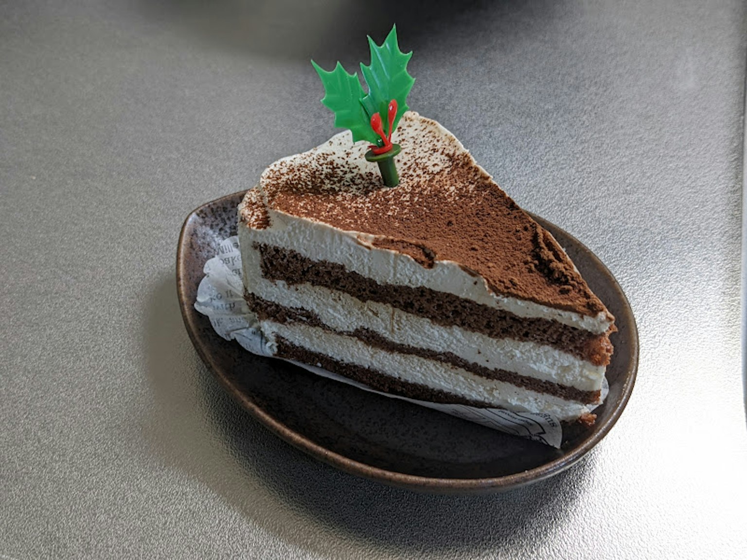 Una fetta di torta al cioccolato con una decorazione natalizia su un piatto