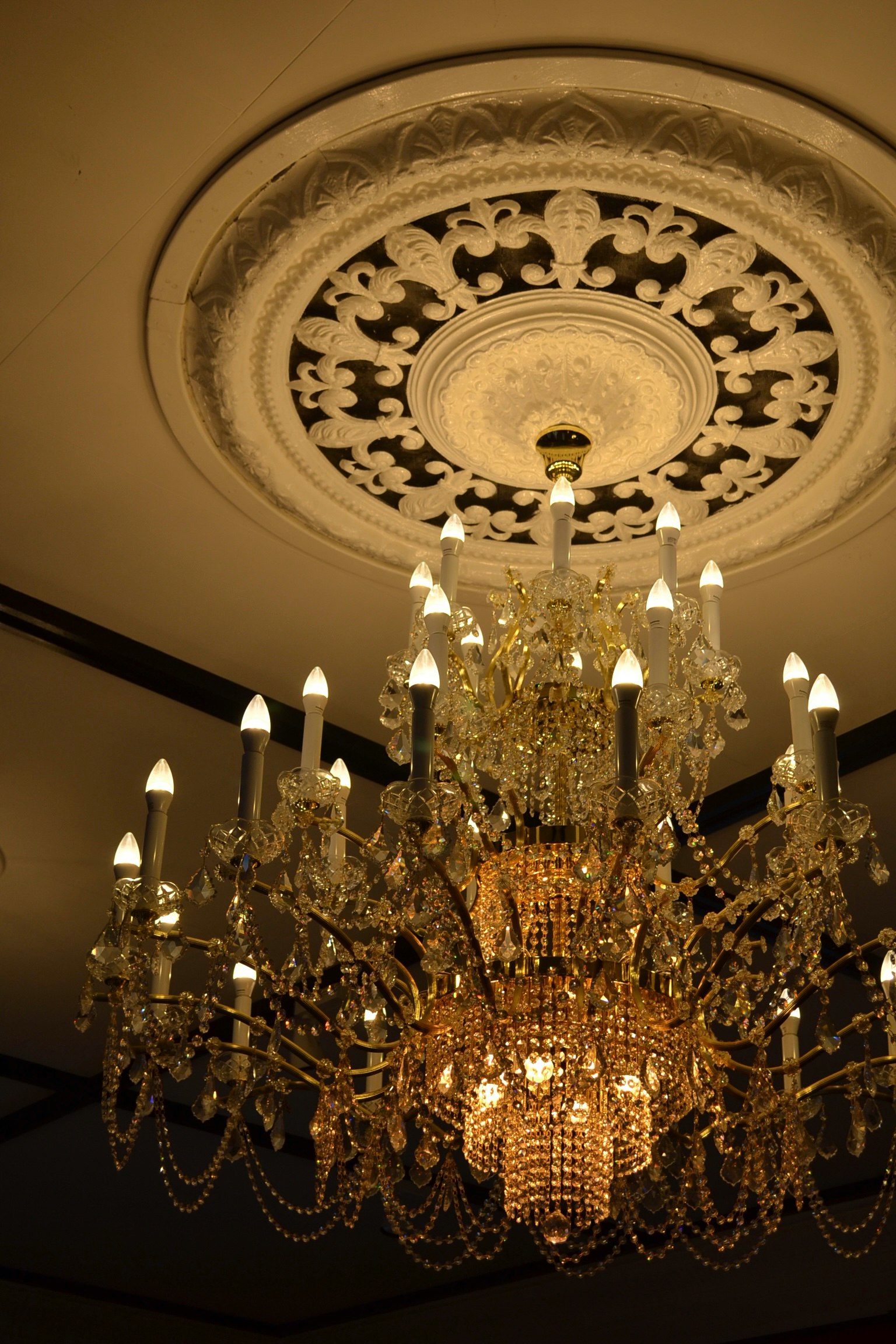 Image of an ornate chandelier with a decorative ceiling