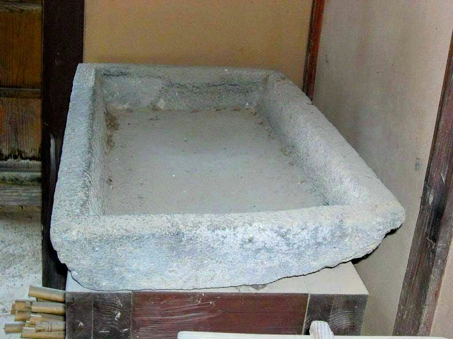Rectangular stone basin placed against a wall