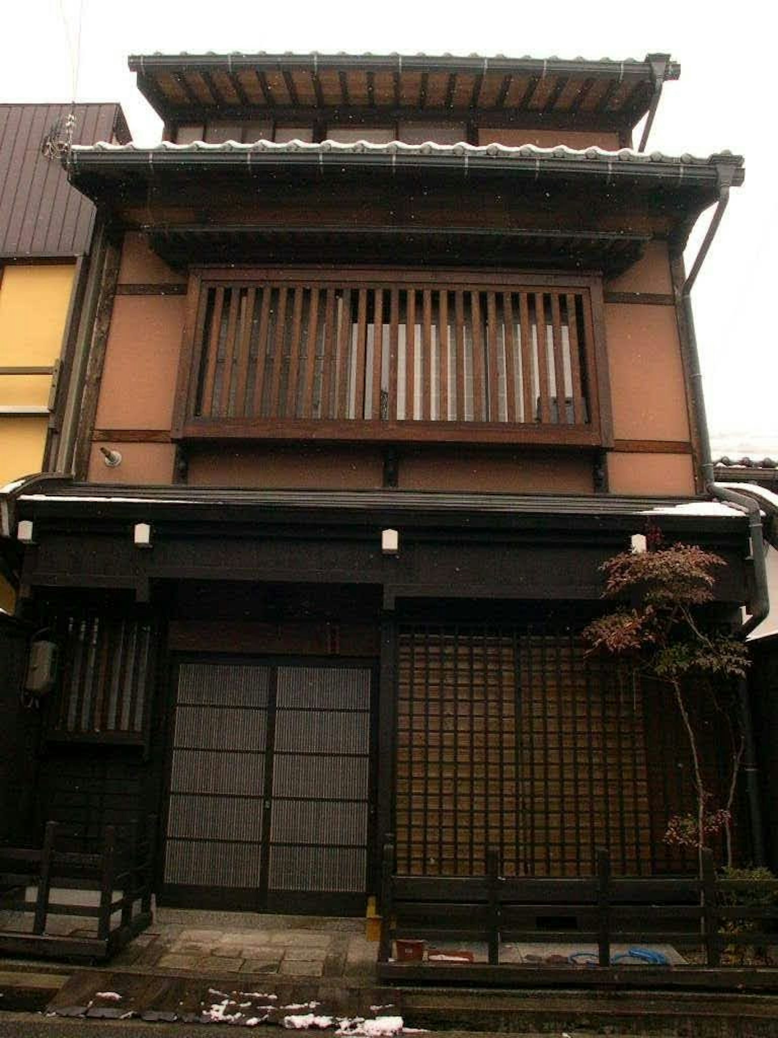 Exterior de una casa japonesa tradicional con ventanas de rejilla de madera