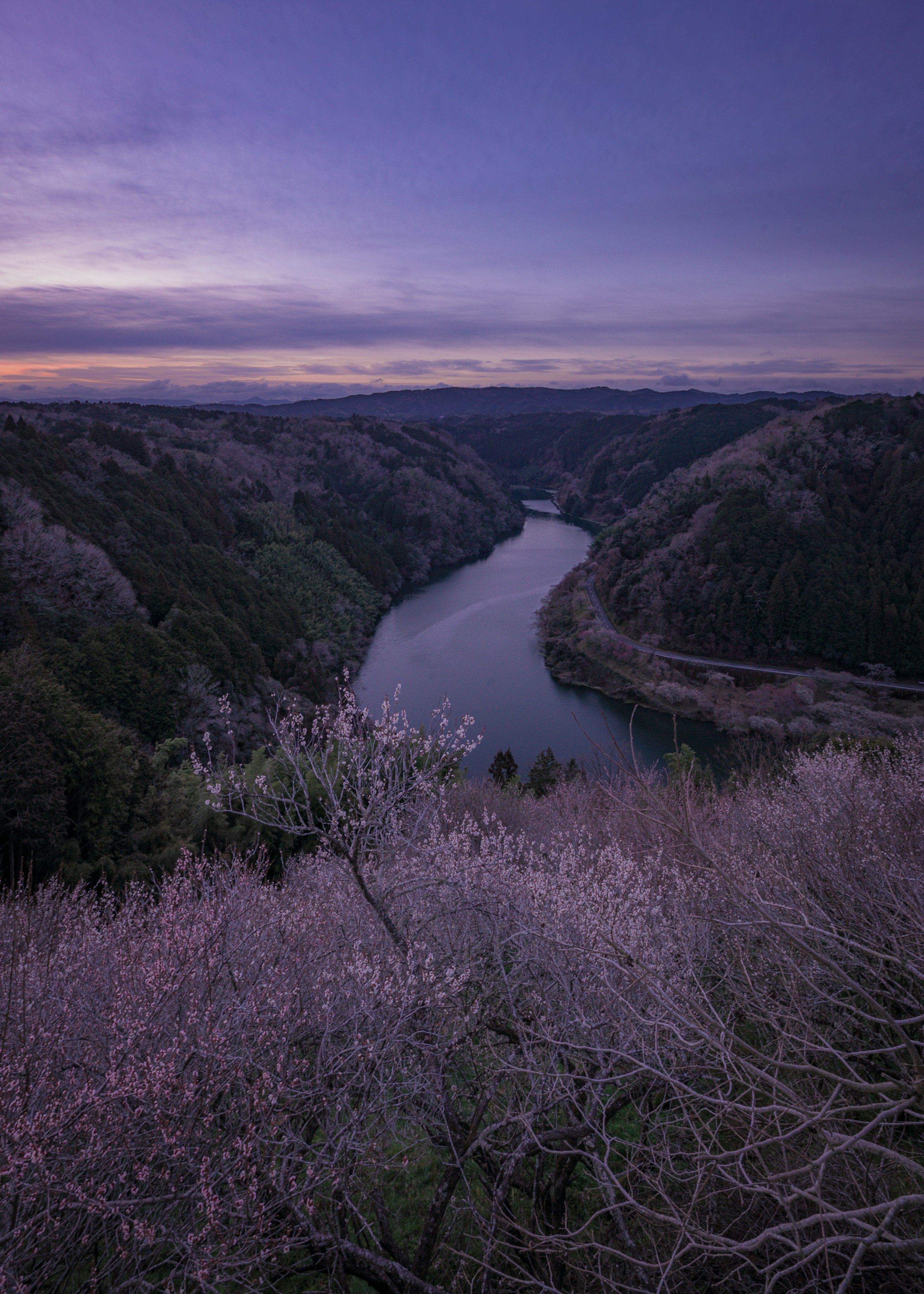 pre-dawn valley landscape overlooking a river and mountain ridges