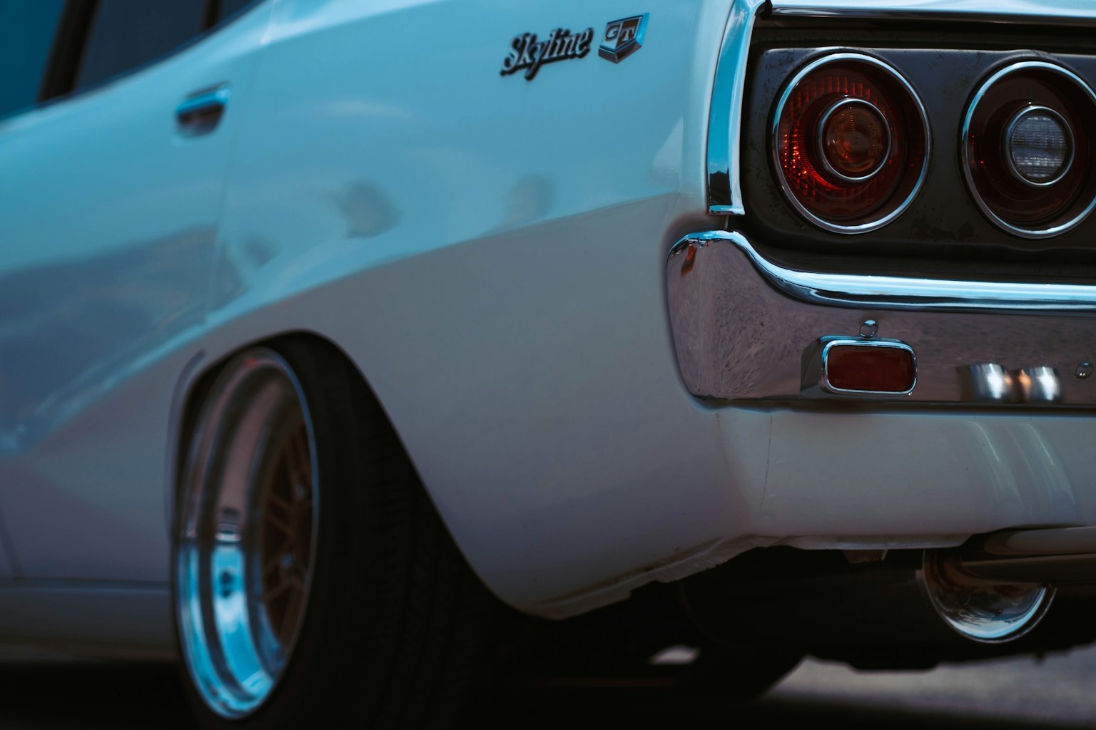 Nahaufnahme des Hecks eines klassischen Autos mit einer eleganten weißen Karosserie und runden Rücklichtern