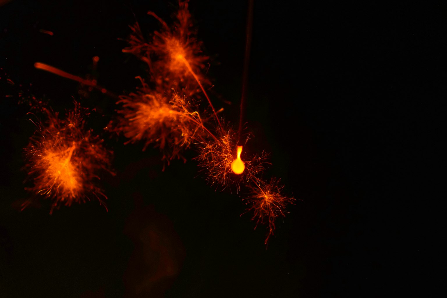 Orange sparks flying against a dark background