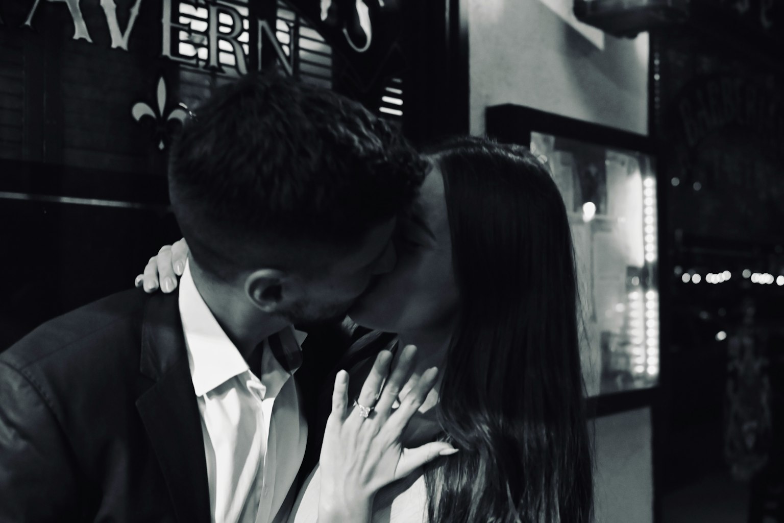 A couple kissing in a black and white photo