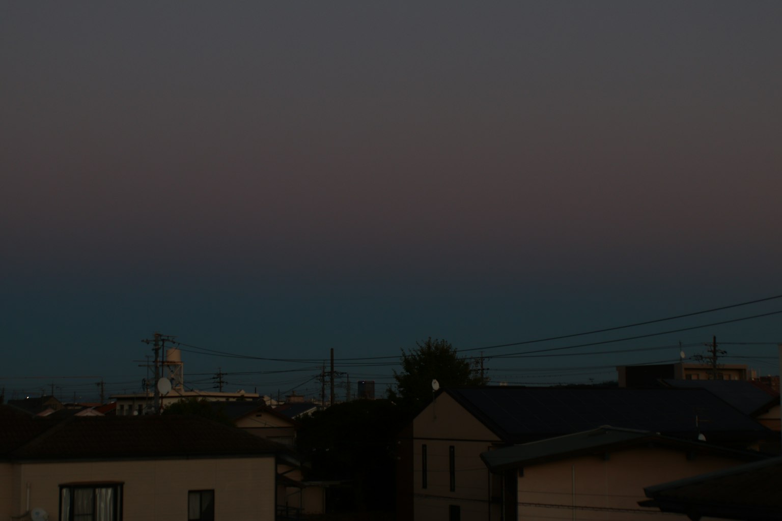 Twilight sky gradient with silhouettes of houses
