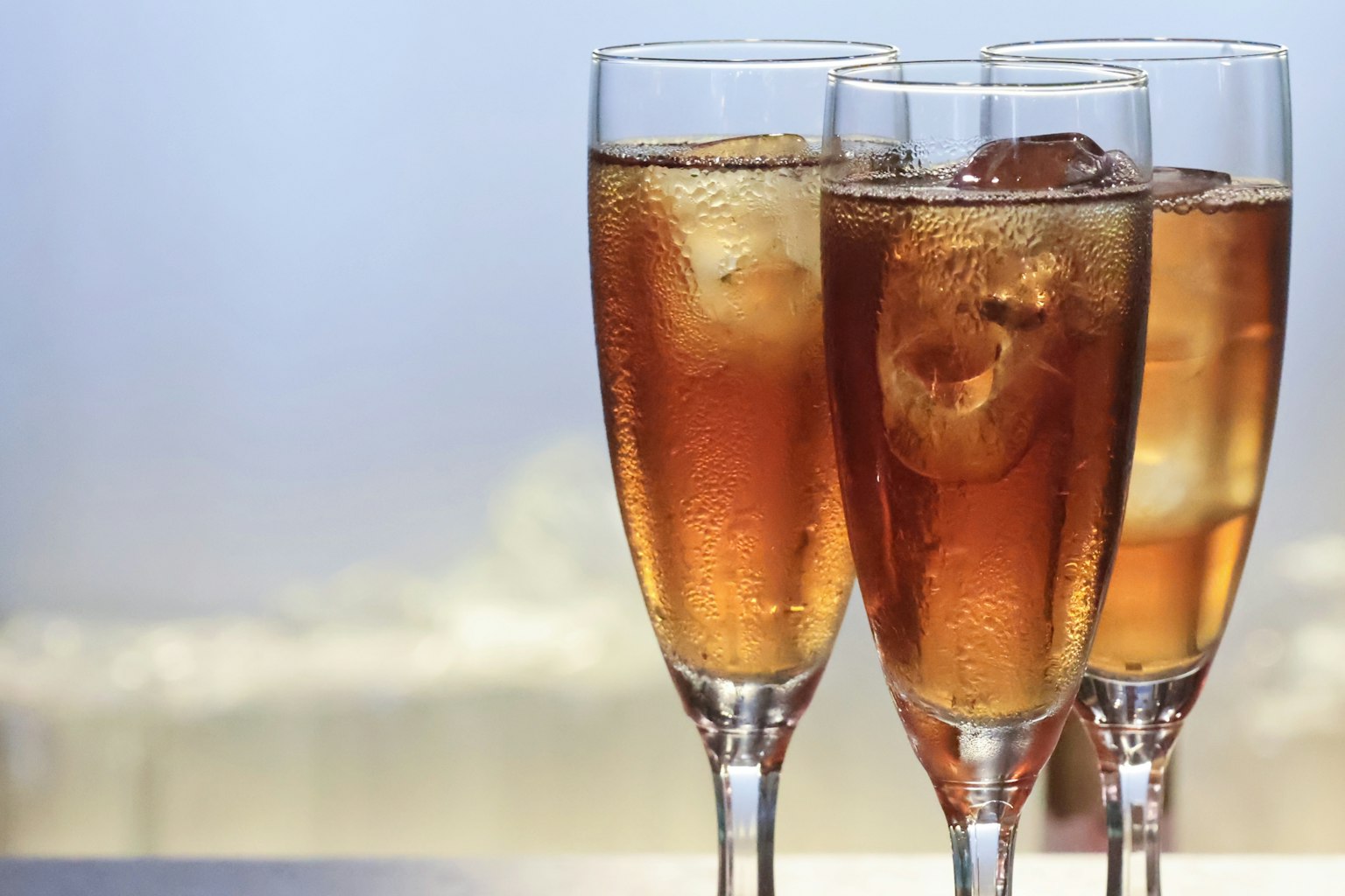 Three glasses filled with iced tea