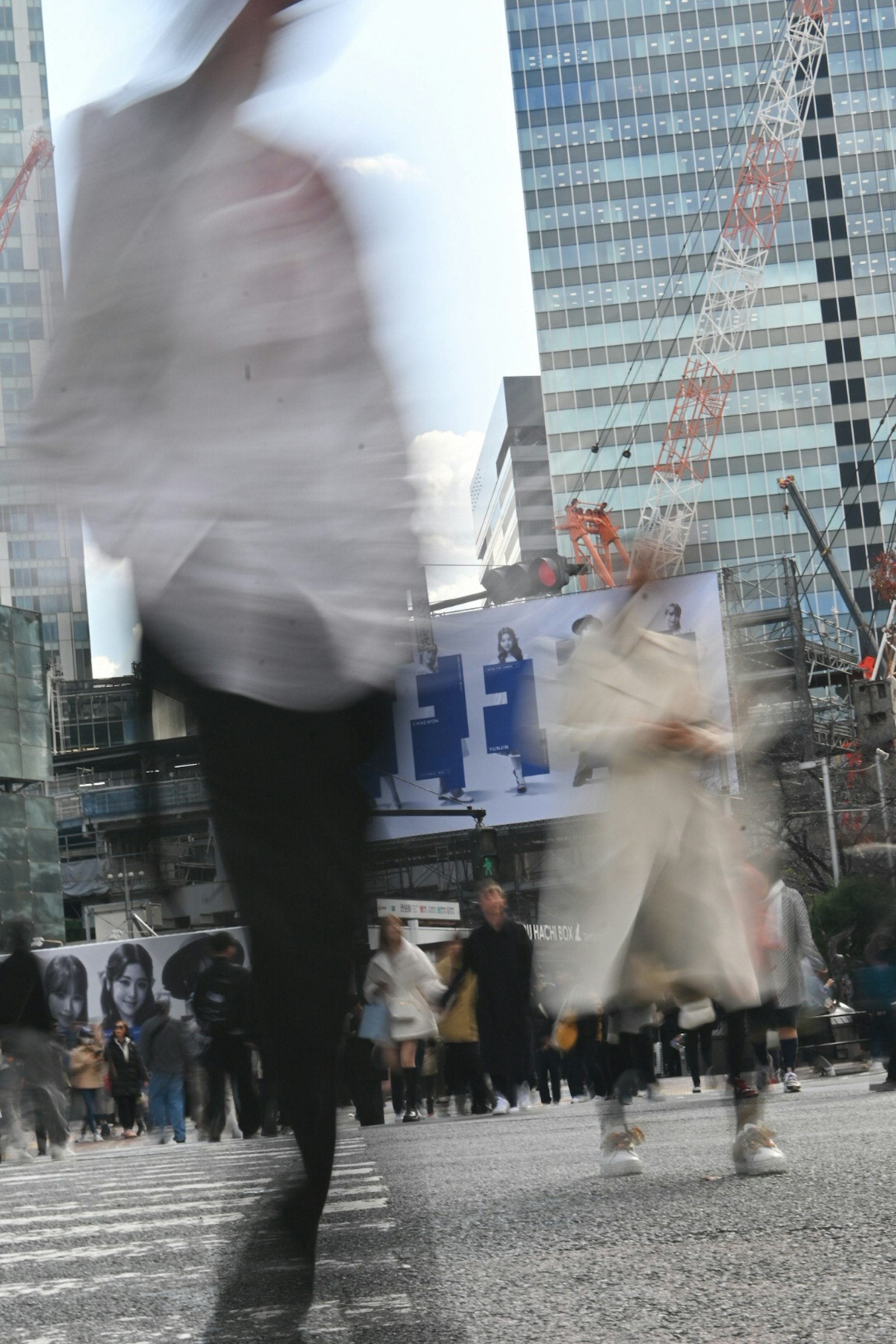Cảnh đường dành cho người đi bộ đông đúc với người đi bộ mờ và các tòa nhà đô thị ở phía sau