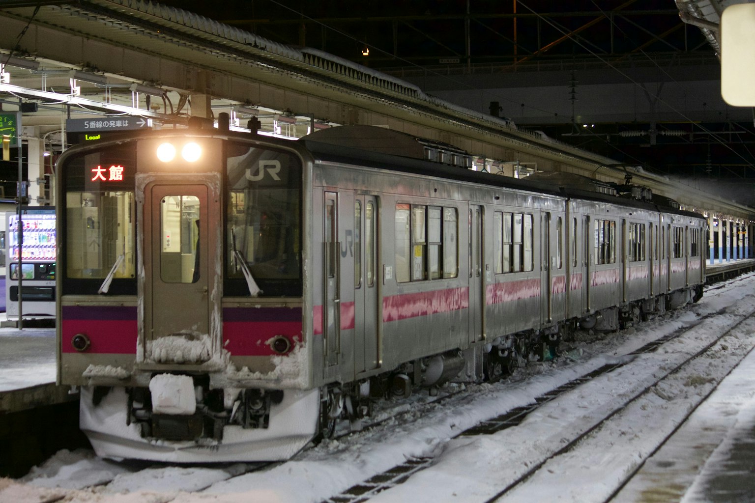 JR train stopped in snow at the station with platform view