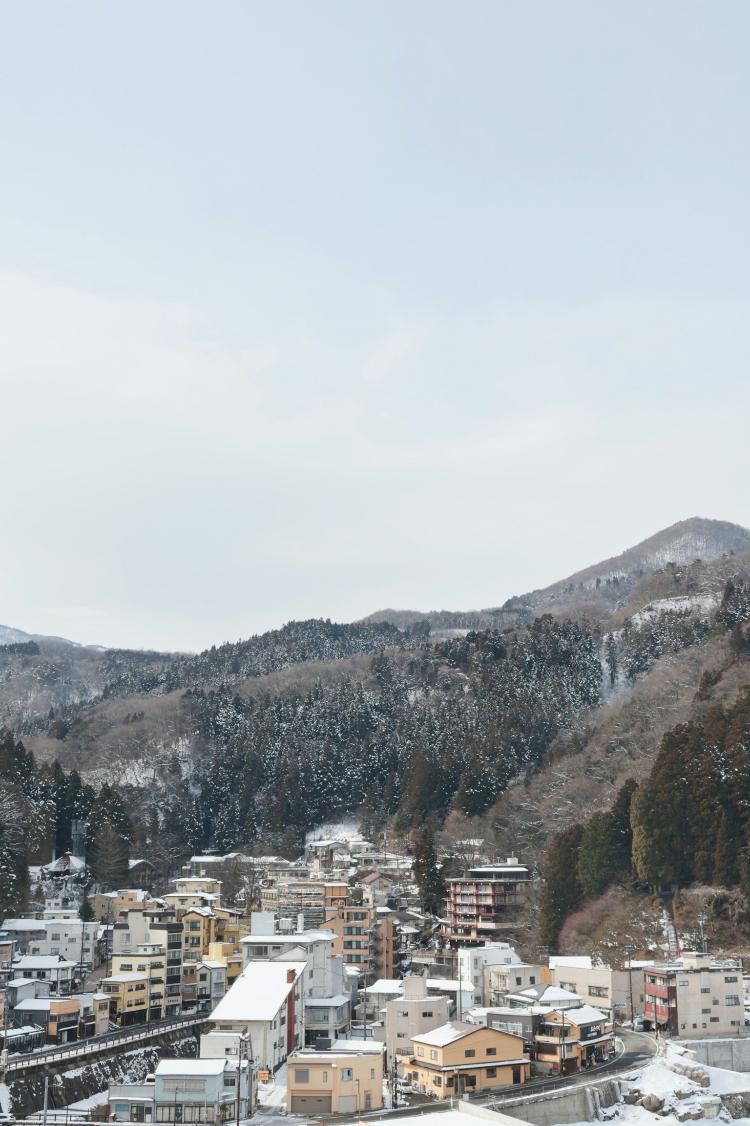 Snow-covered mountains and a hot spring town landscape
