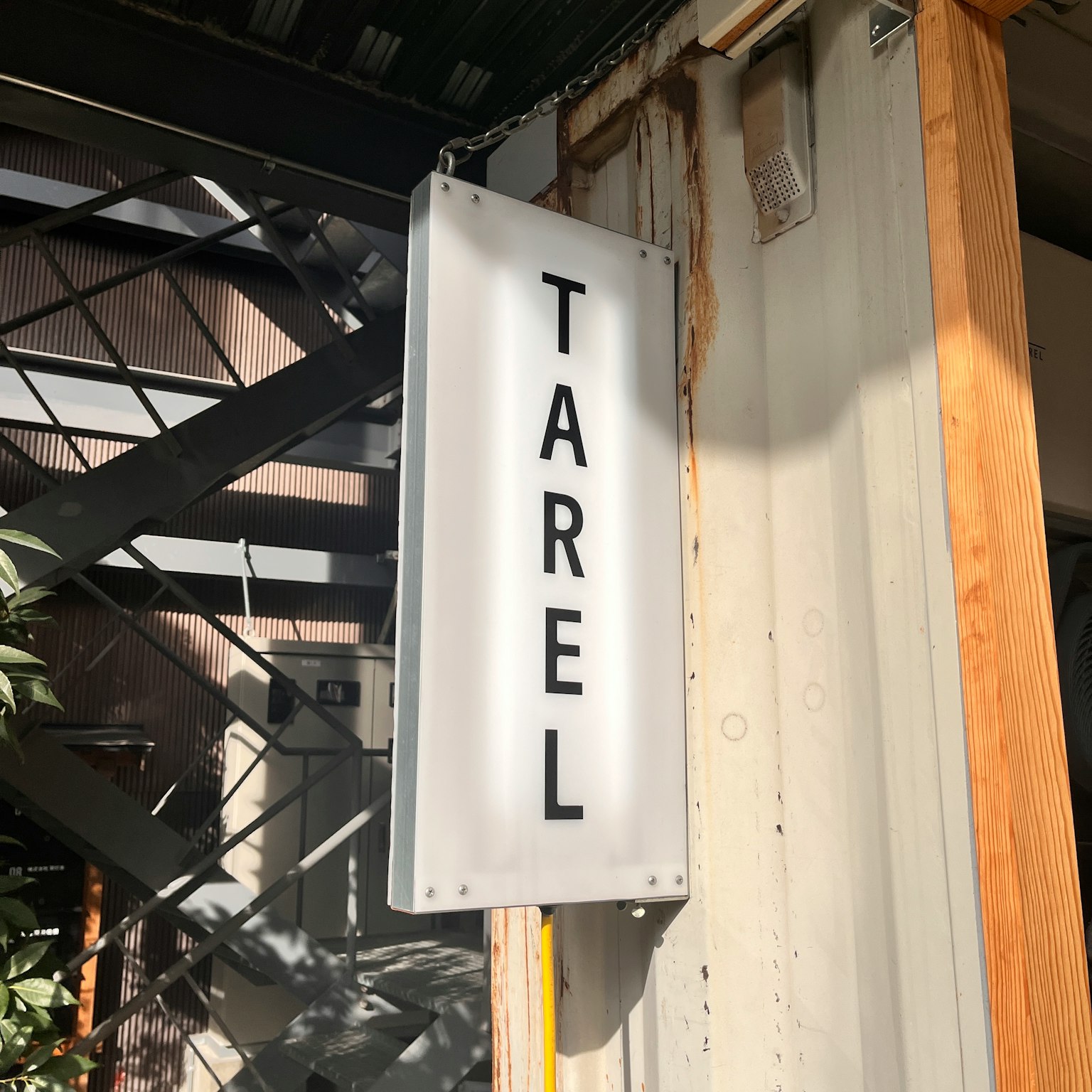A white sign with black letters displaying the word TAREL