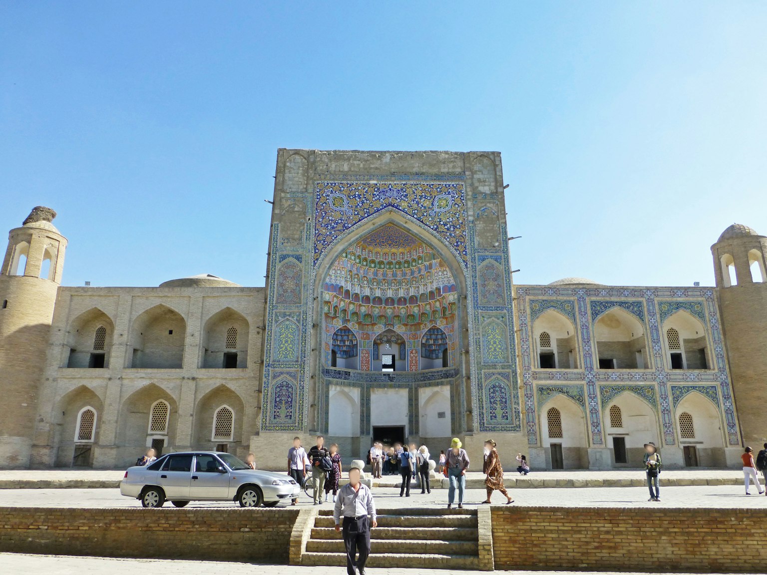 Beautiful exterior of a mosque in Uzbekistan with tourists