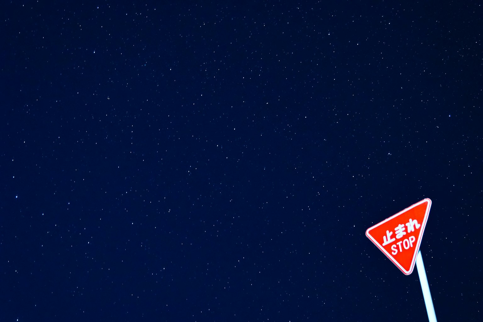 Starry night sky with a red stop sign