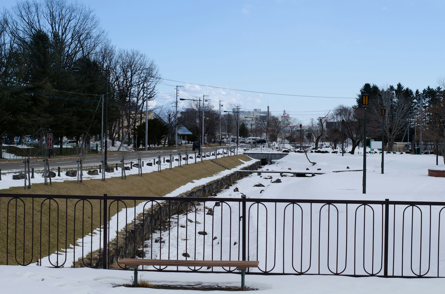 Snow-covered park scene with a bench