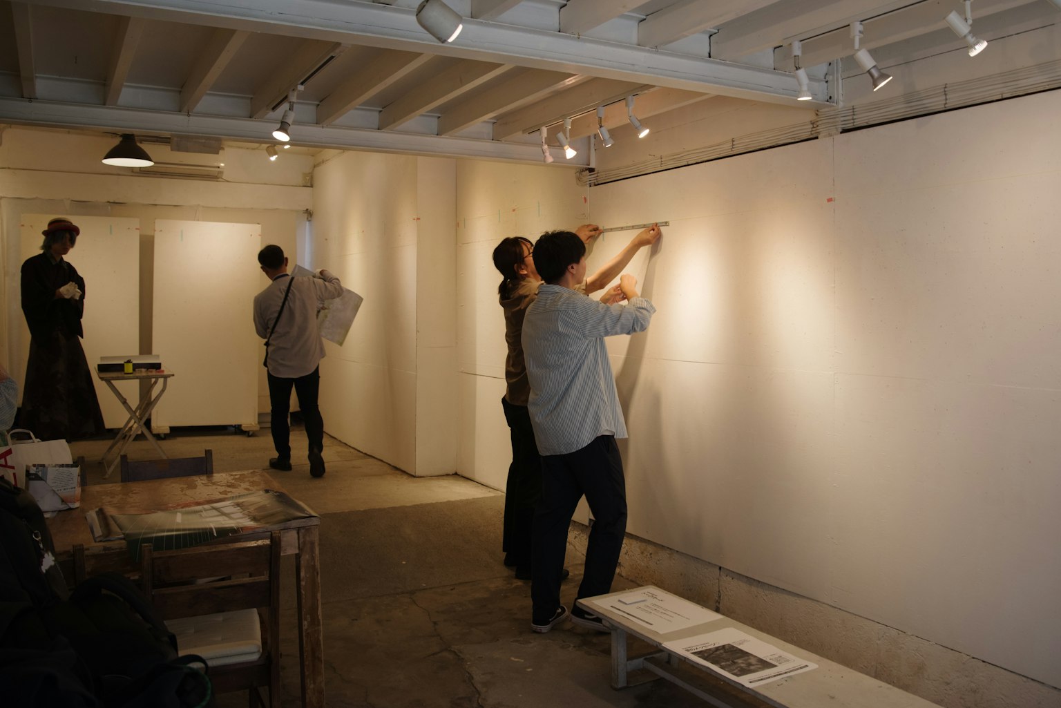 People preparing to display artwork in an art gallery