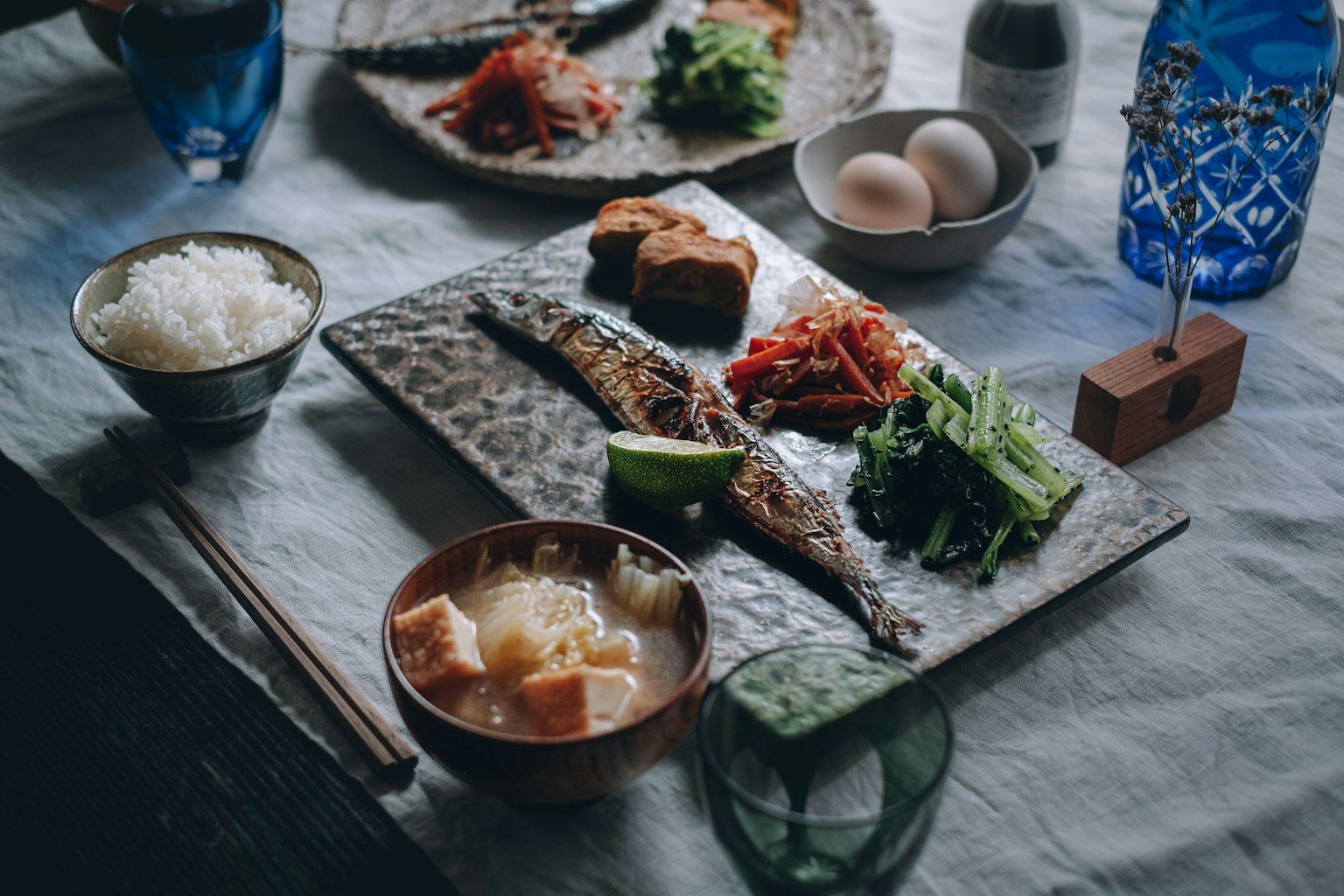 a beautifully arranged Japanese meal featuring grilled fish and rice