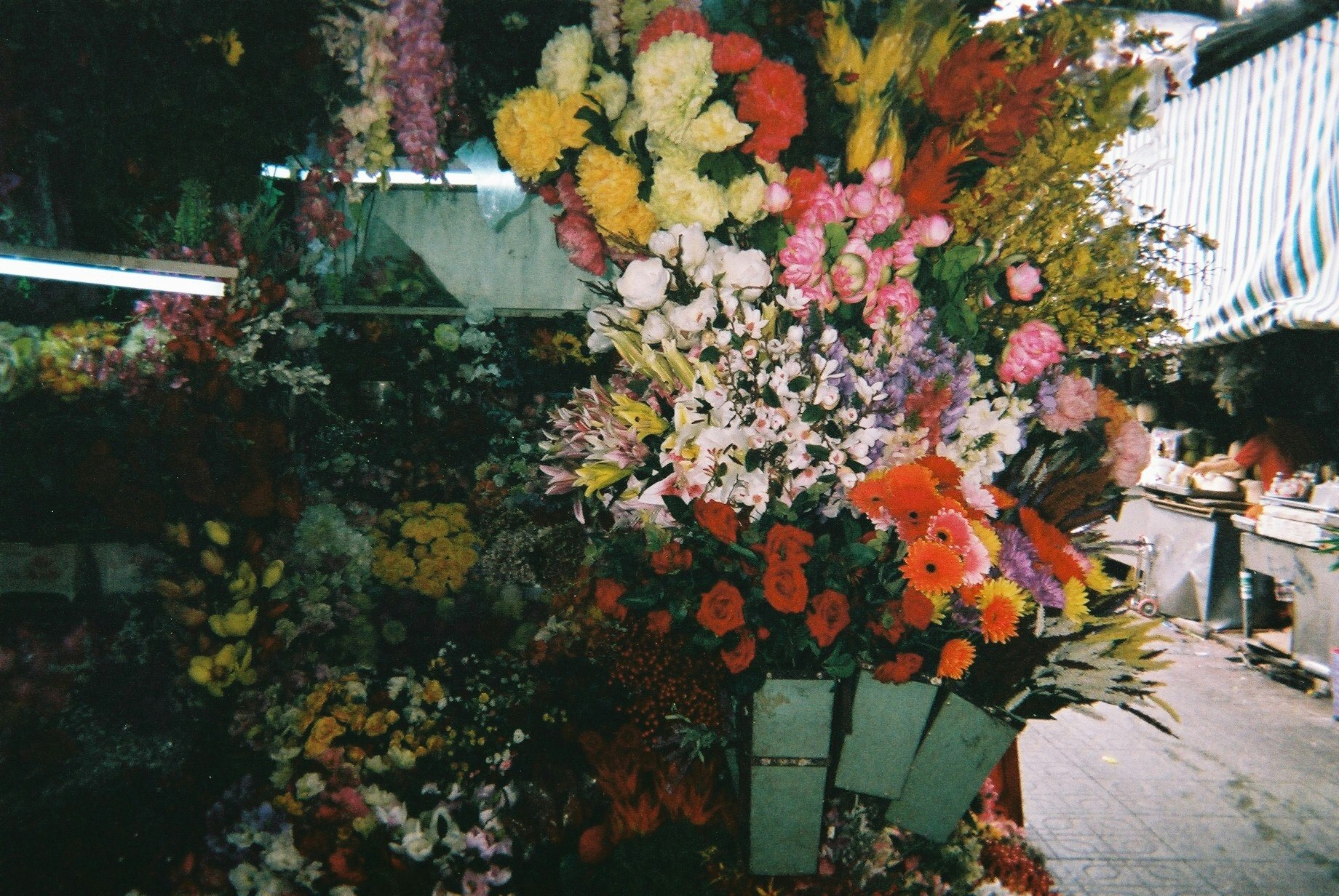 colorful bouquets lined up at an outdoor flower shop storefront