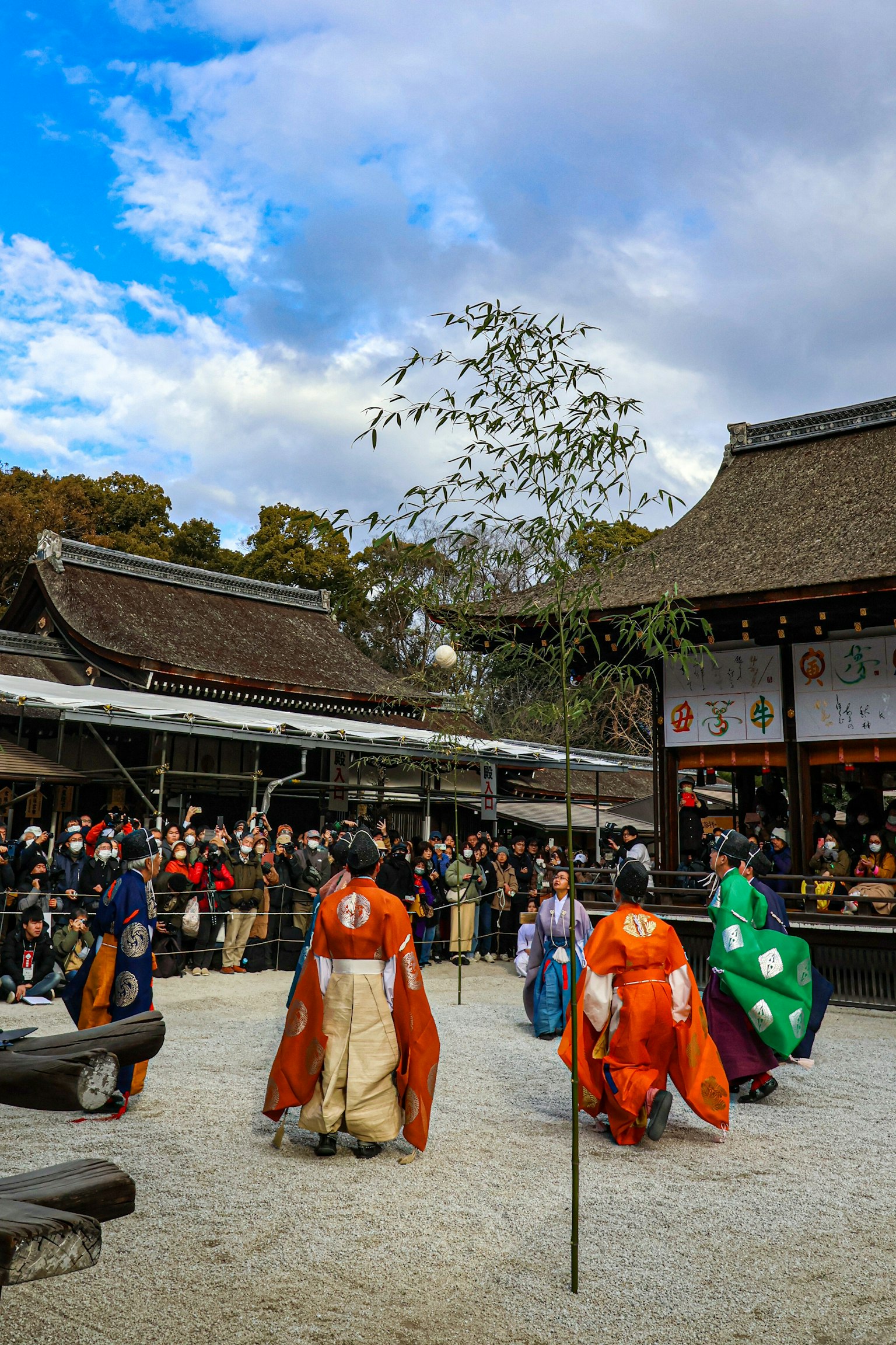 传统日本节日，舞者穿着色彩缤纷的服装，在观众围绕的庭院中表演