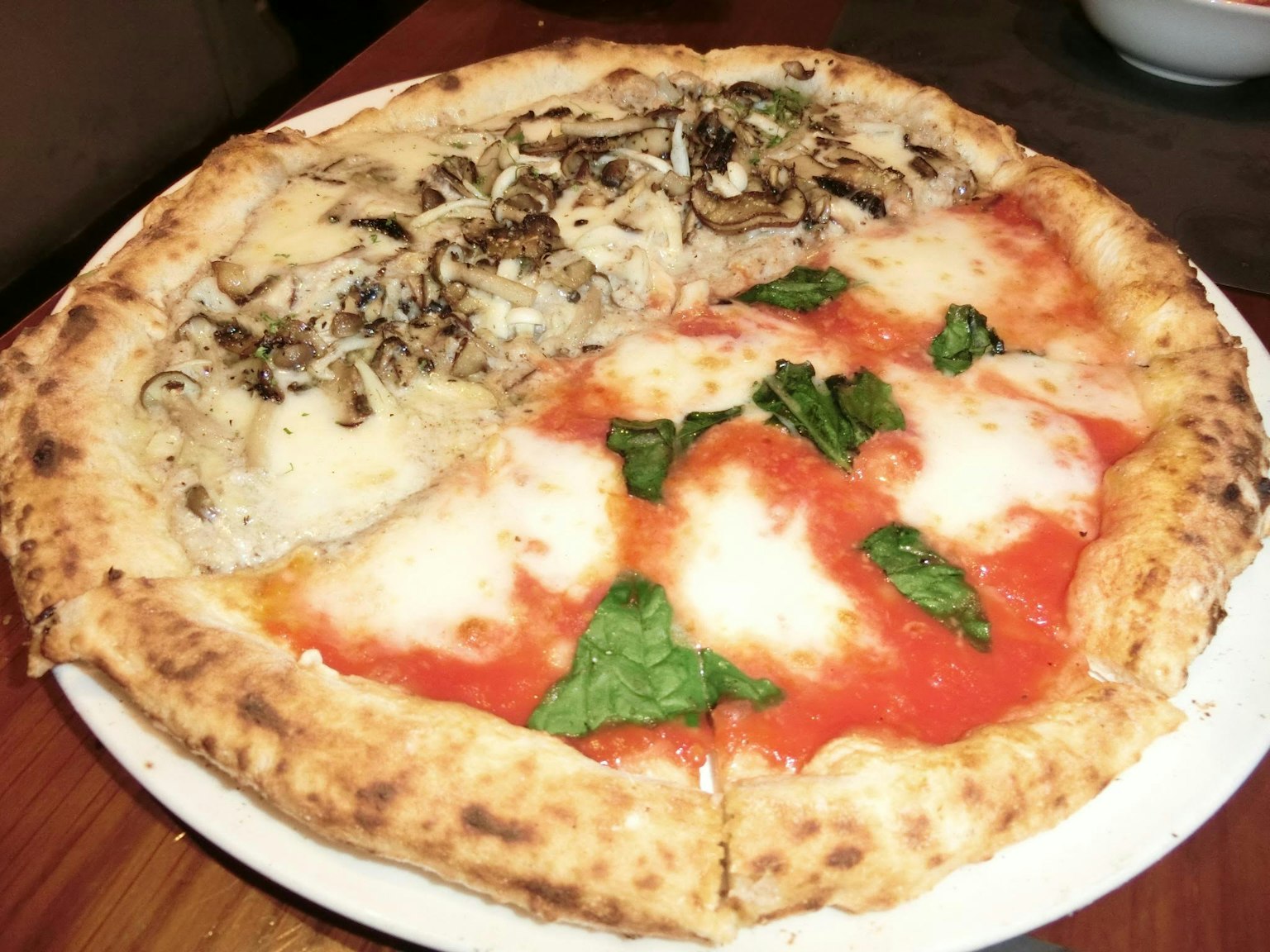 Delicious pizza with half Margherita and half mushroom topping