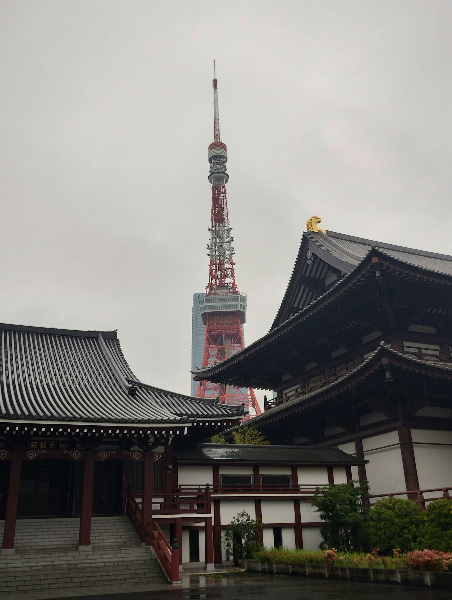 View of Tokyo Tower behind traditional Japanese architecture