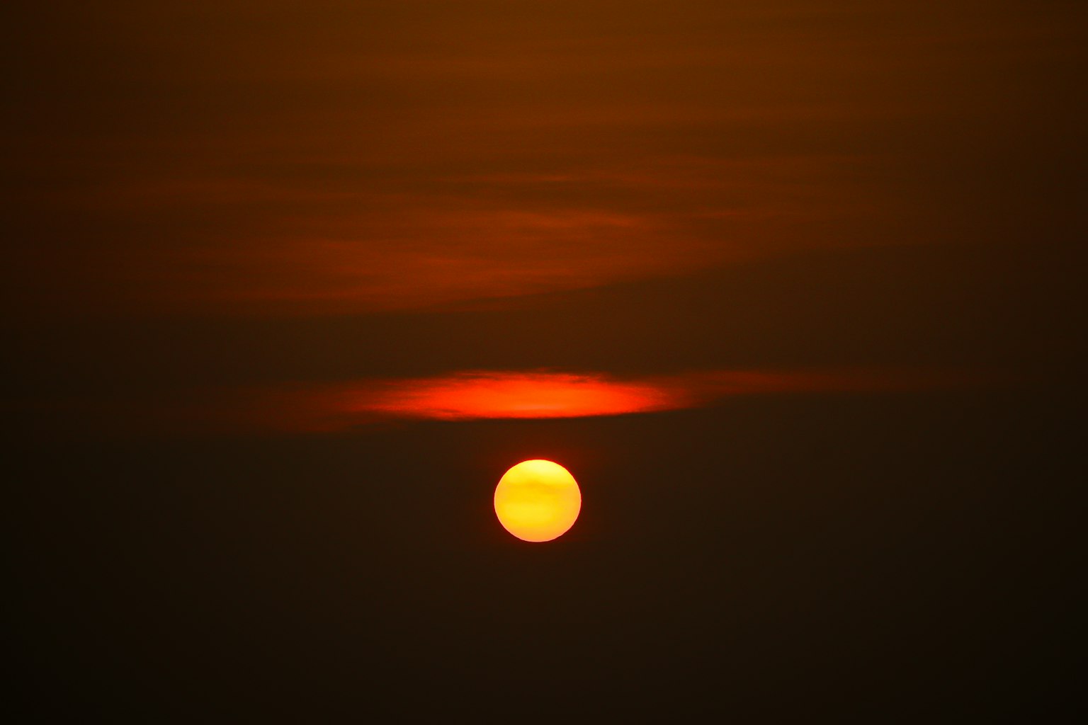 Beautiful sunset with the sun visible through clouds