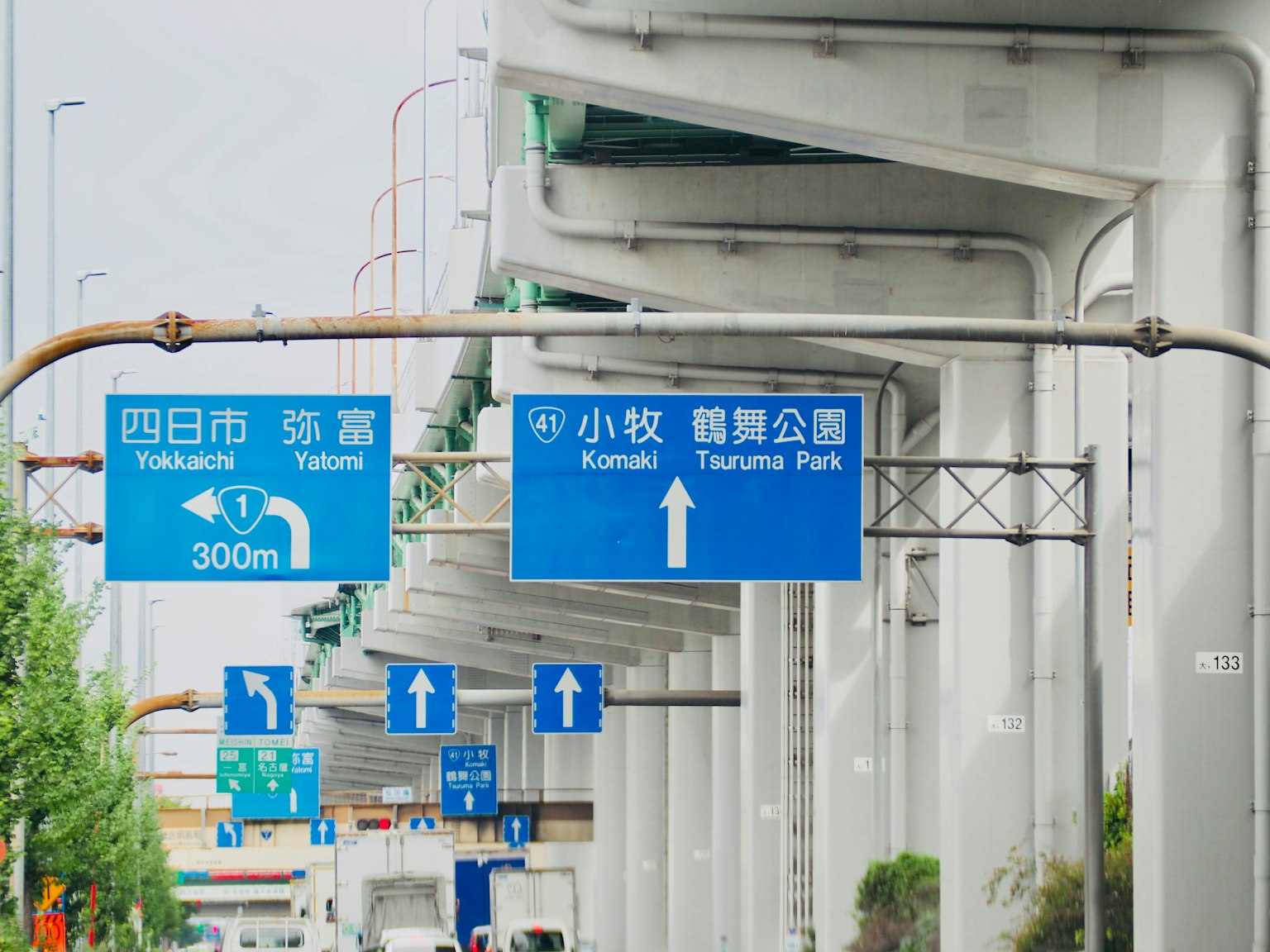 City view with blue road signs and elevated highway