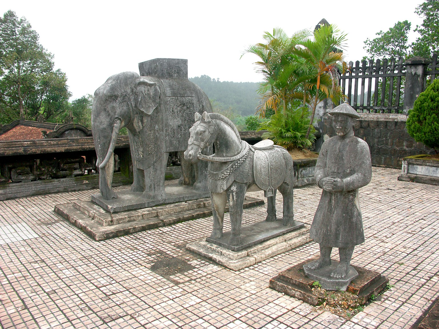 Patung batu gajah dan kuda dengan sosok berdiri