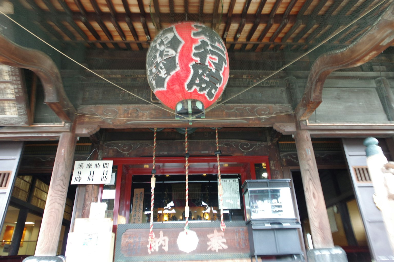 Entrance of a traditional Japanese building with a red lantern hanging