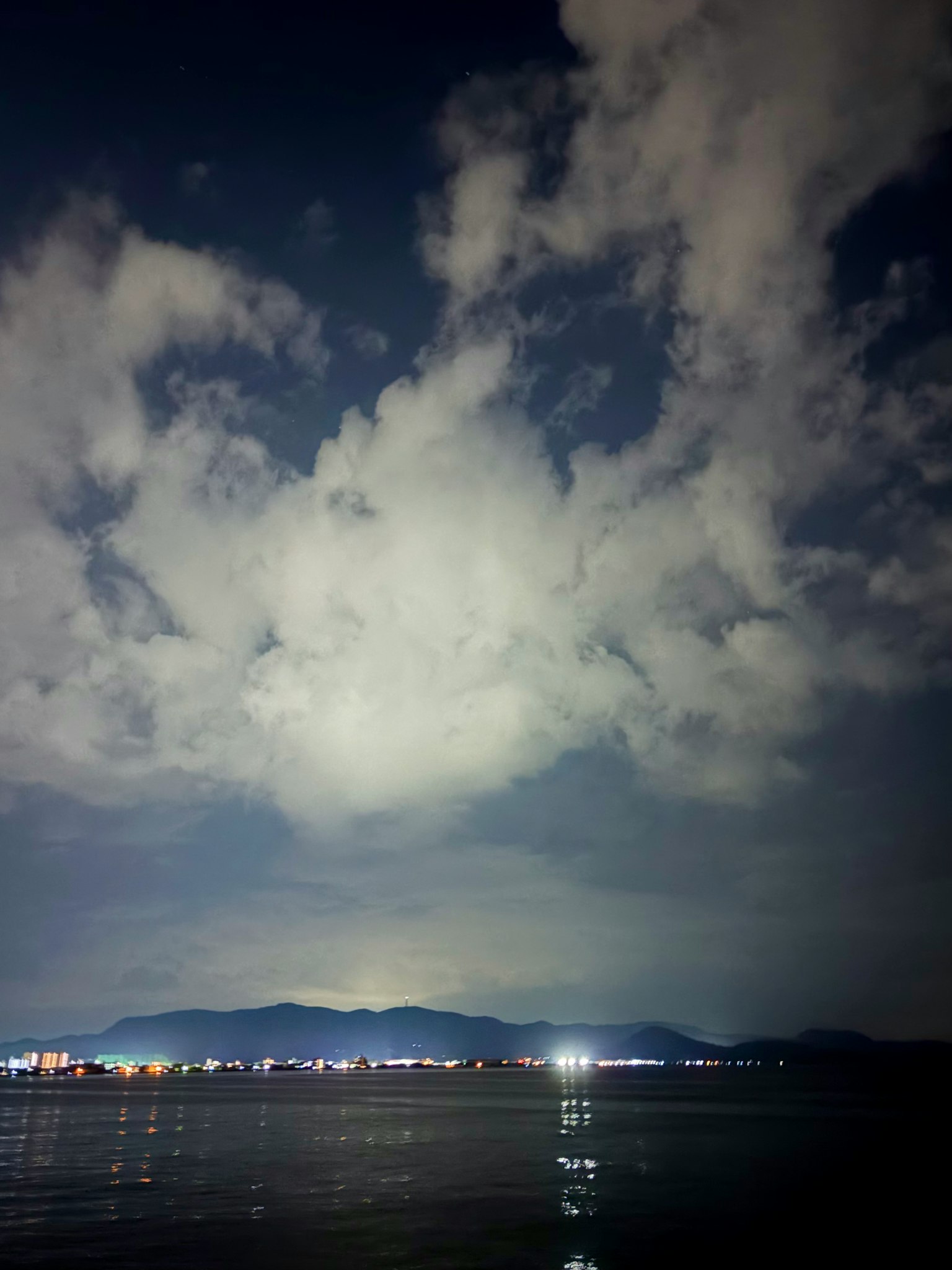 夜空に浮かぶ雲と静かな海の風景
