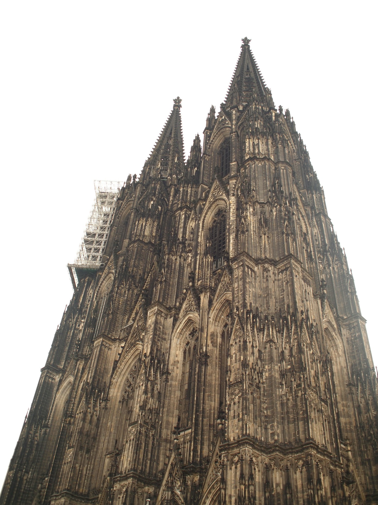 A low-angle view of the tall spires of St. Vitus Cathedral in Prague