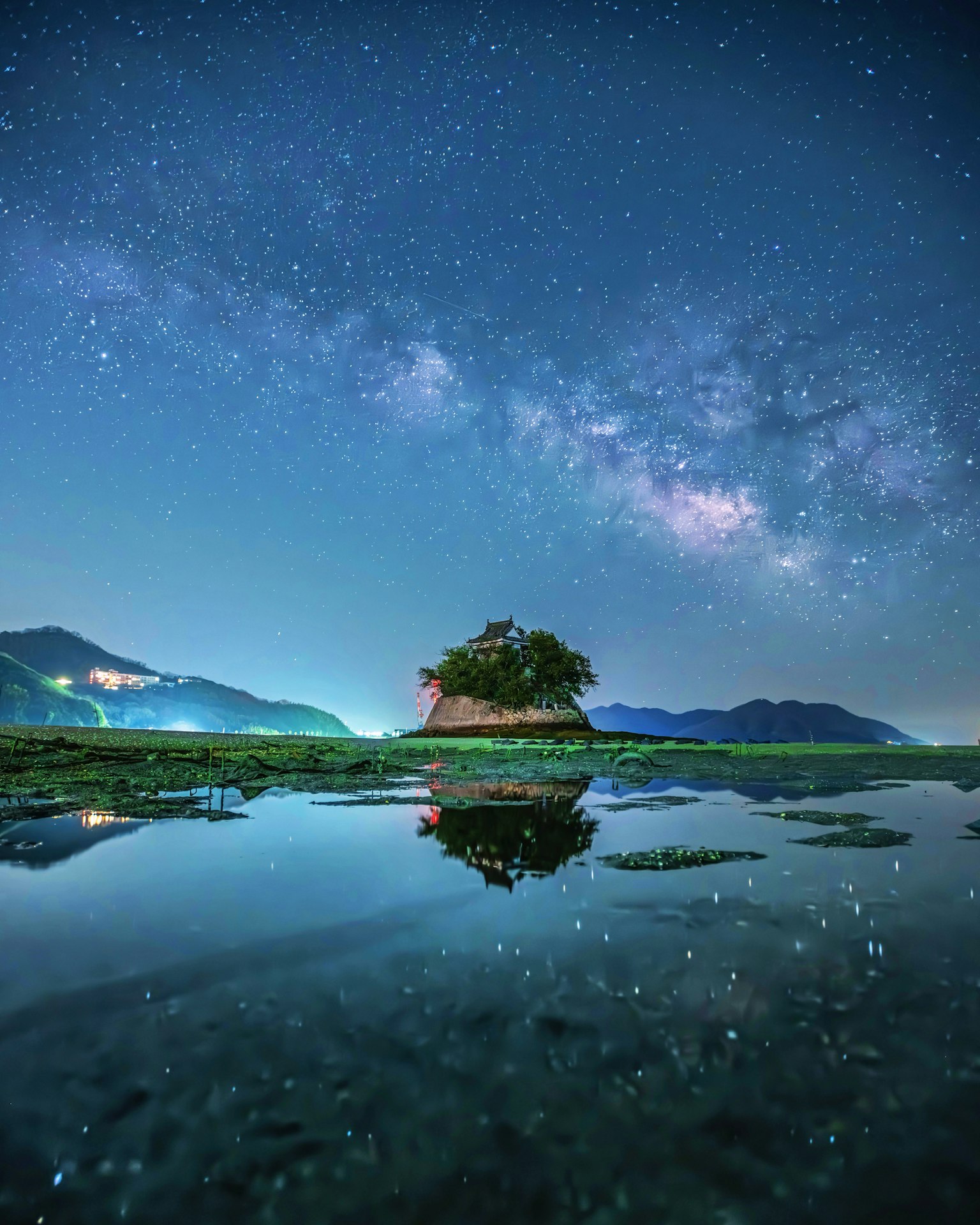 Pemandangan indah dengan pulau kecil dan pantulan di bawah langit berbintang