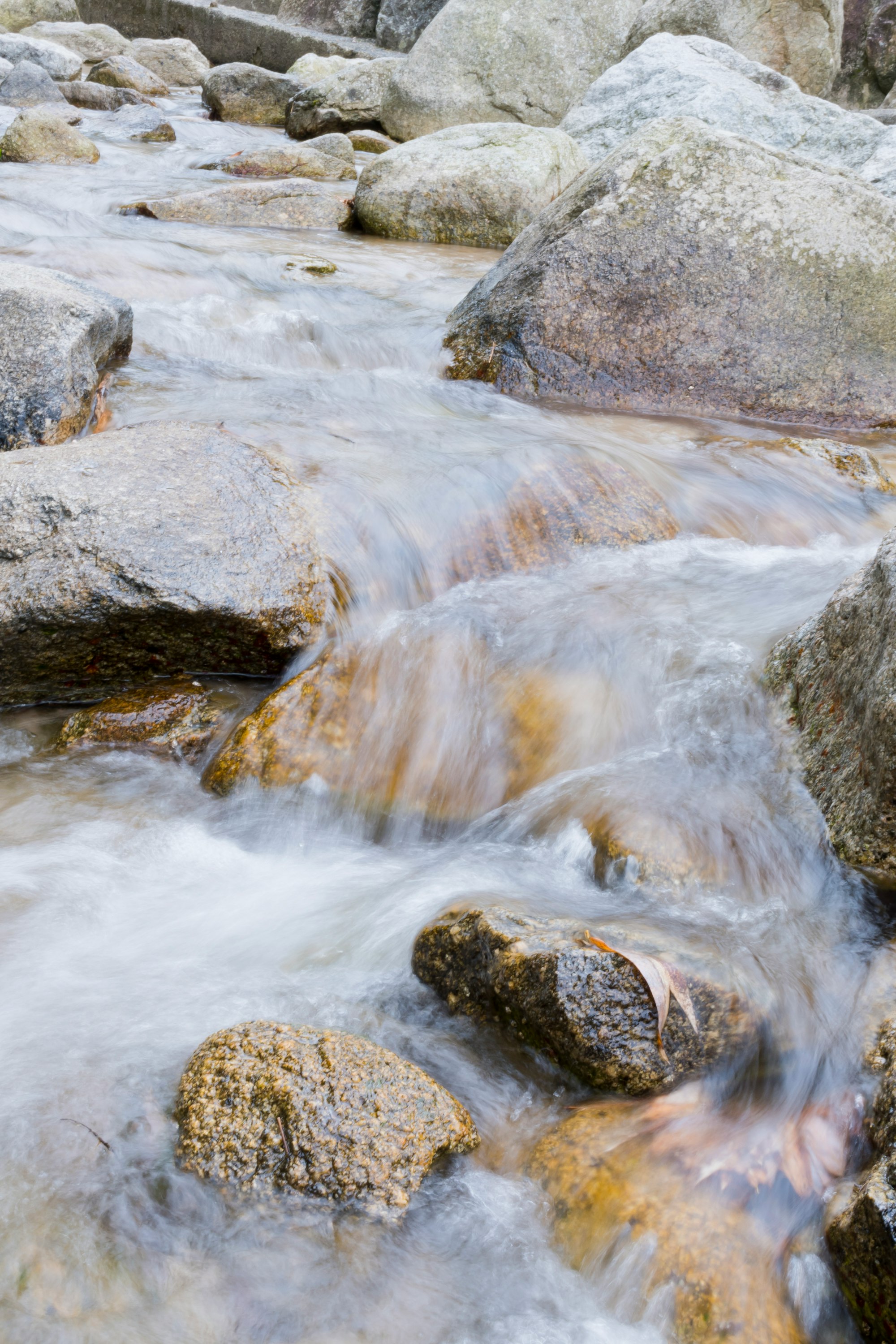 stream water flowing between rocks