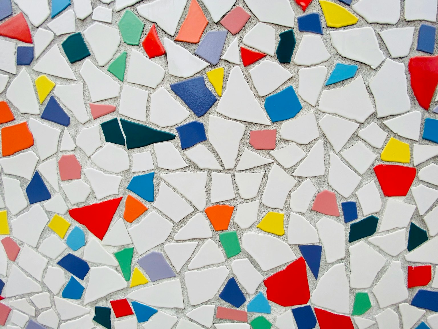 Colorful mosaic tiles arranged on a white background