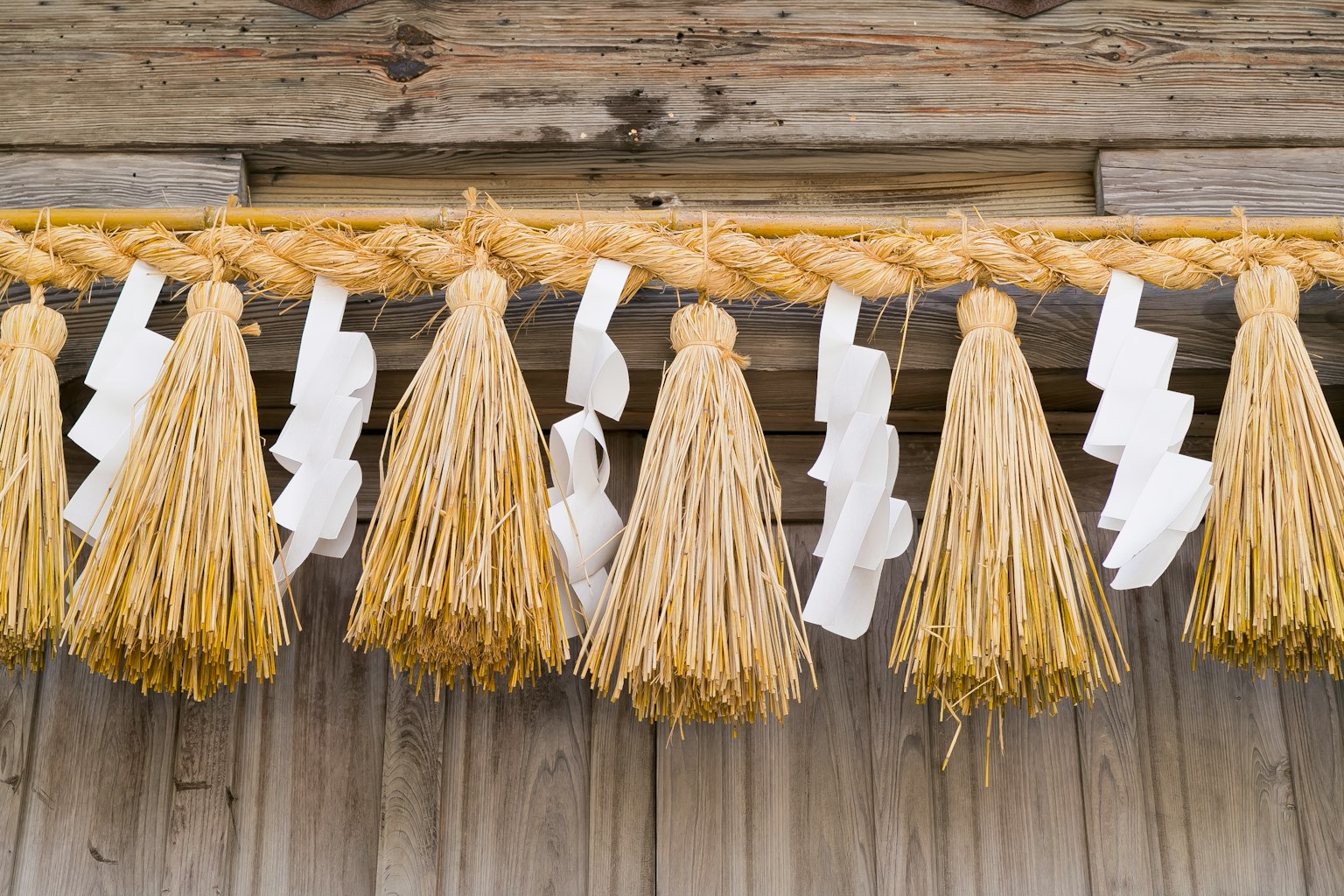 Traditional Japanese decoration featuring straw tassels and white paper embellishments