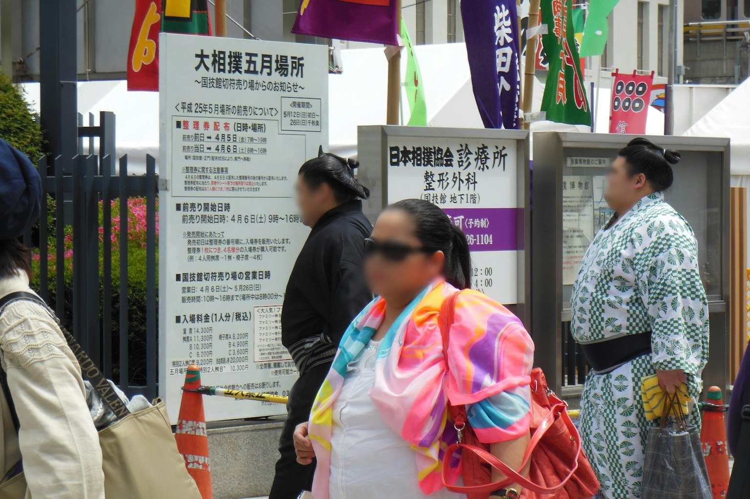 Người gần địa điểm sumo với biển hiệu