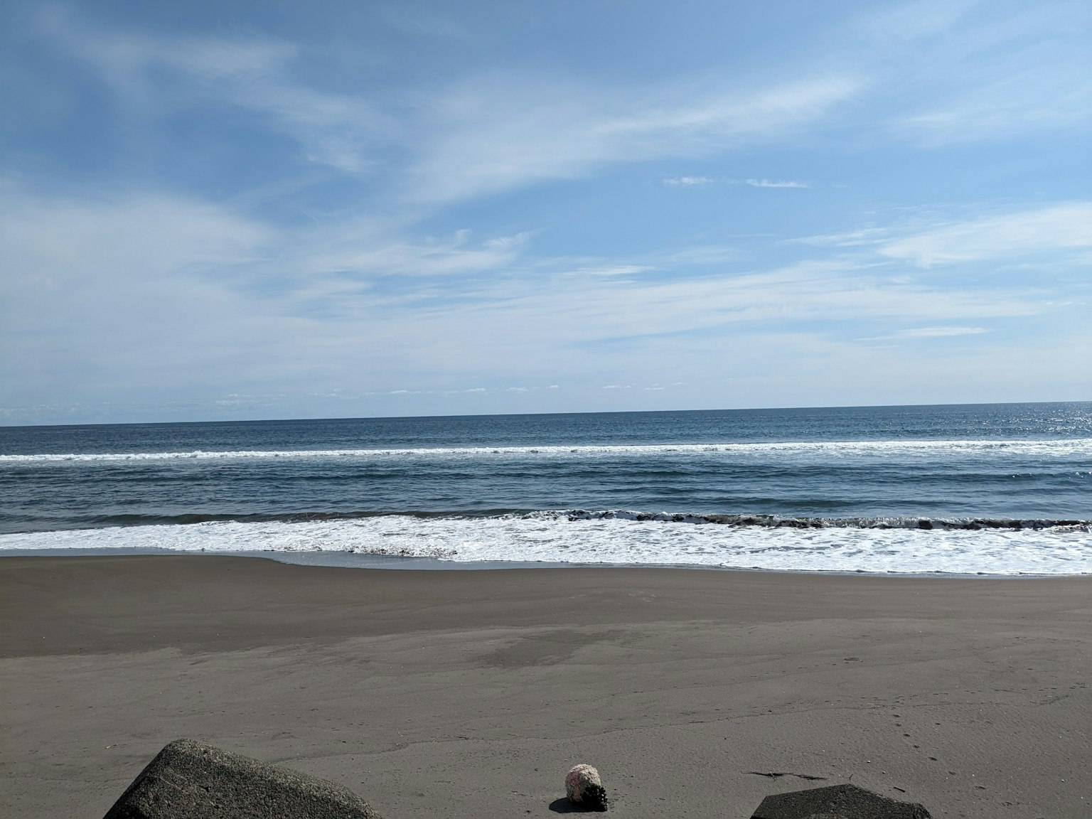 Scenic view of blue ocean and sky with waves on sandy beach