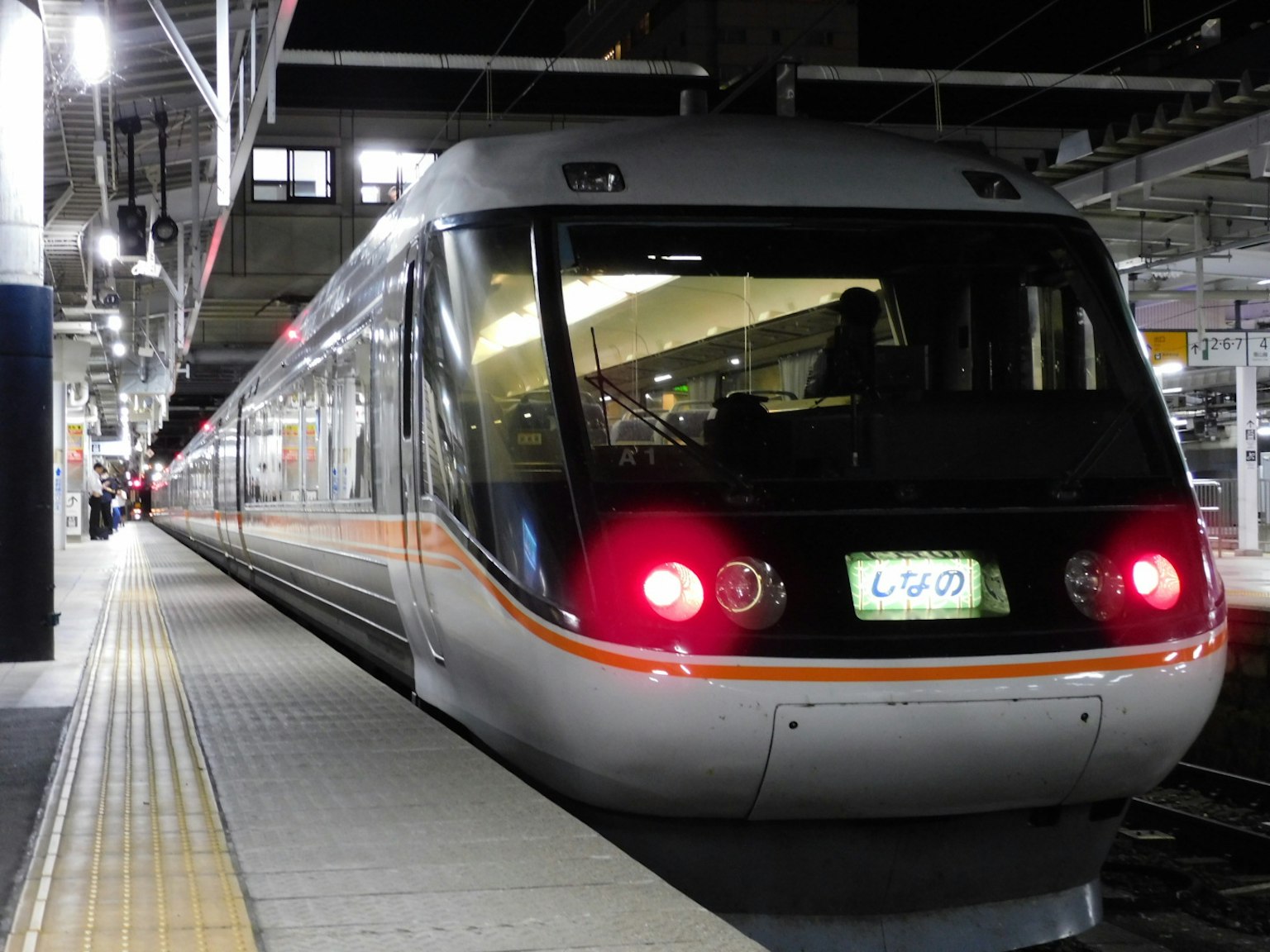 Shinkansen train stopped at a station at night
