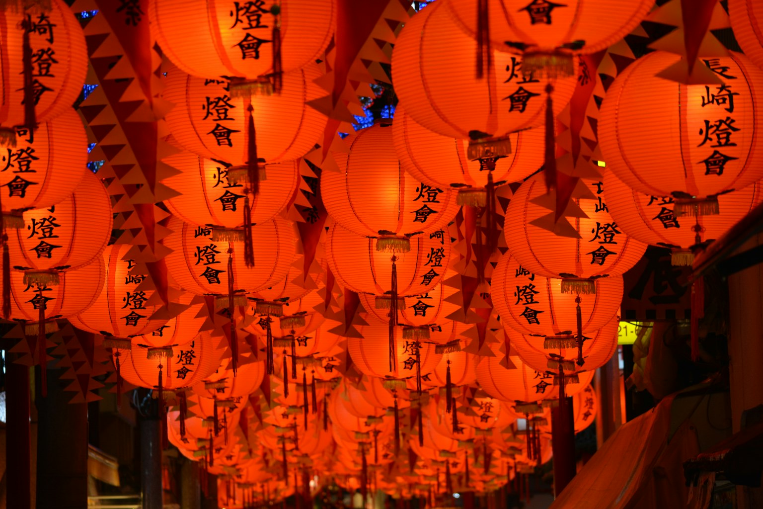 A vibrant display of red lanterns illuminated at night