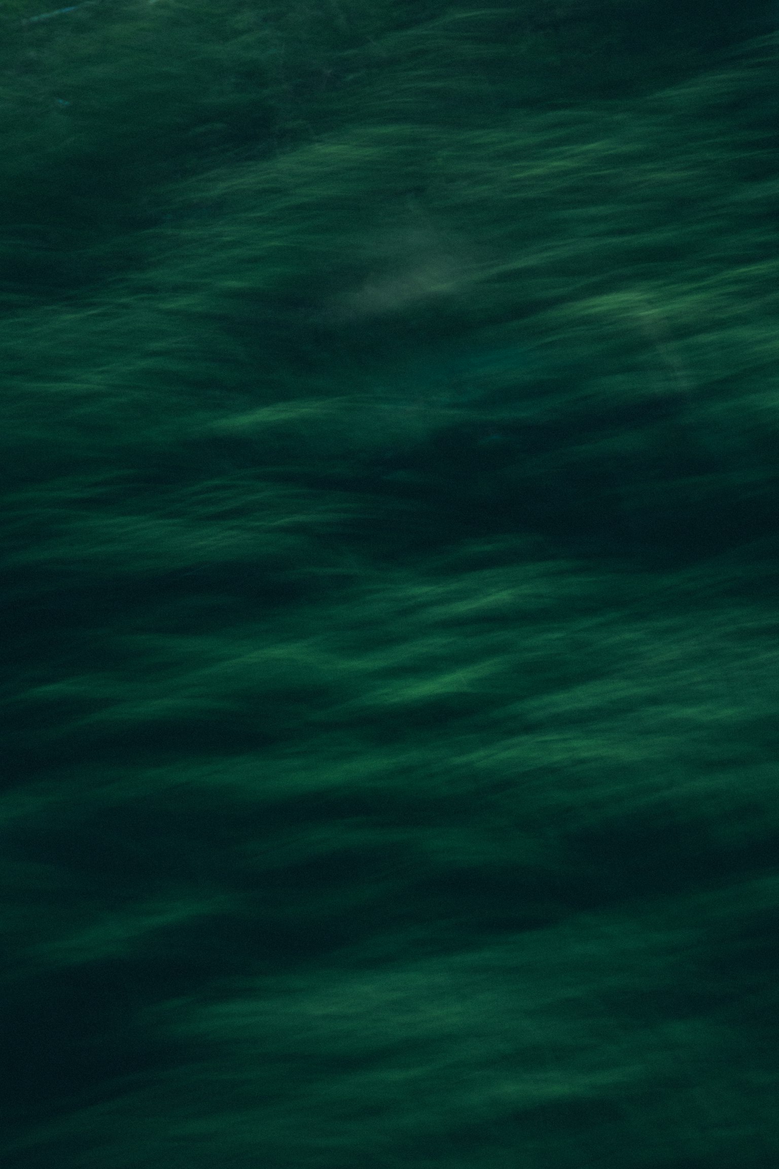 Abstract image of flowing green water surface